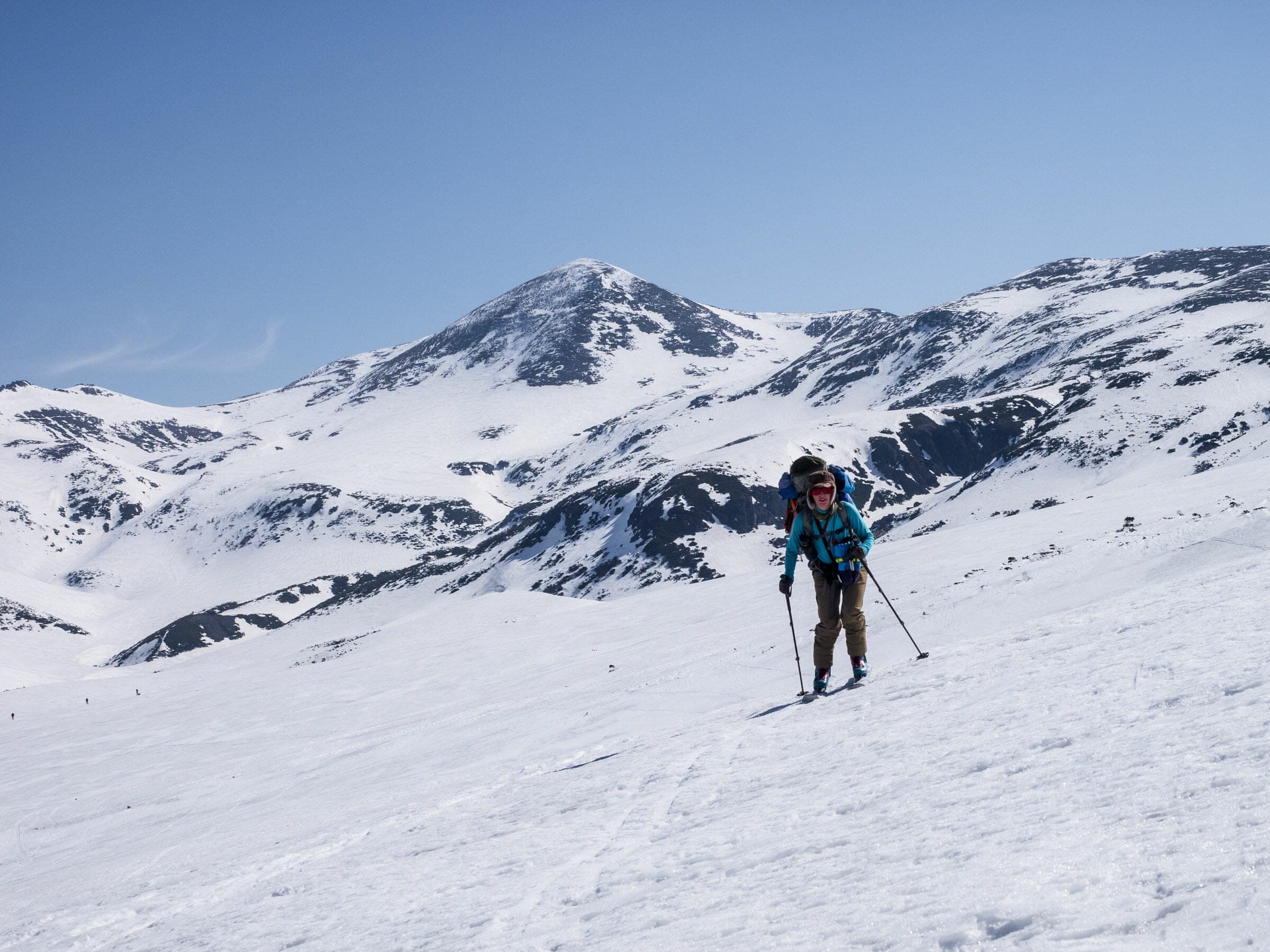 A ski tourer climbs open alpine slopes on the Asahidake to Nakadake Onsen loop in the Daisetsuzan