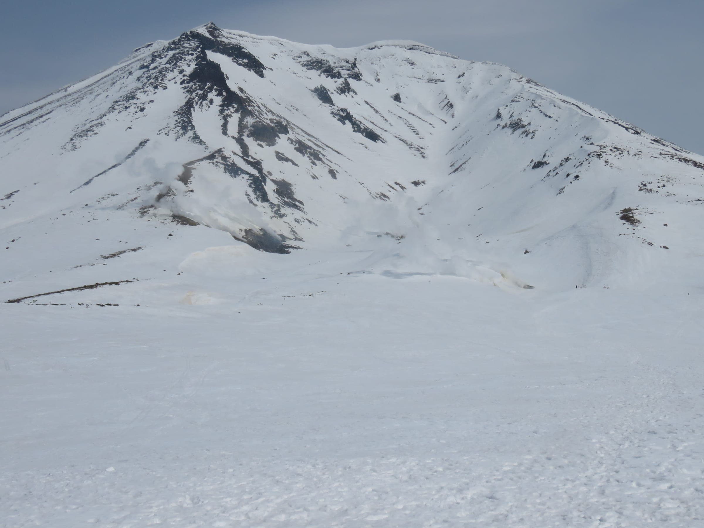 Asahidake's snow-covered summit cone rises above the plateau near the upper ropeway station