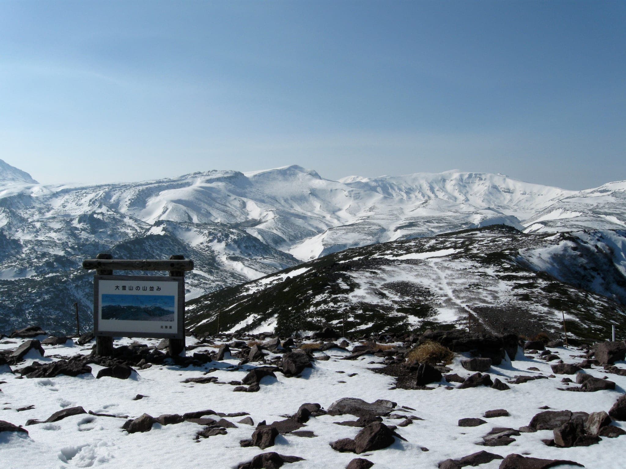 Fresh snow covers the Daisetsuzan plateau and peaks seen west from the summit of Kurodake