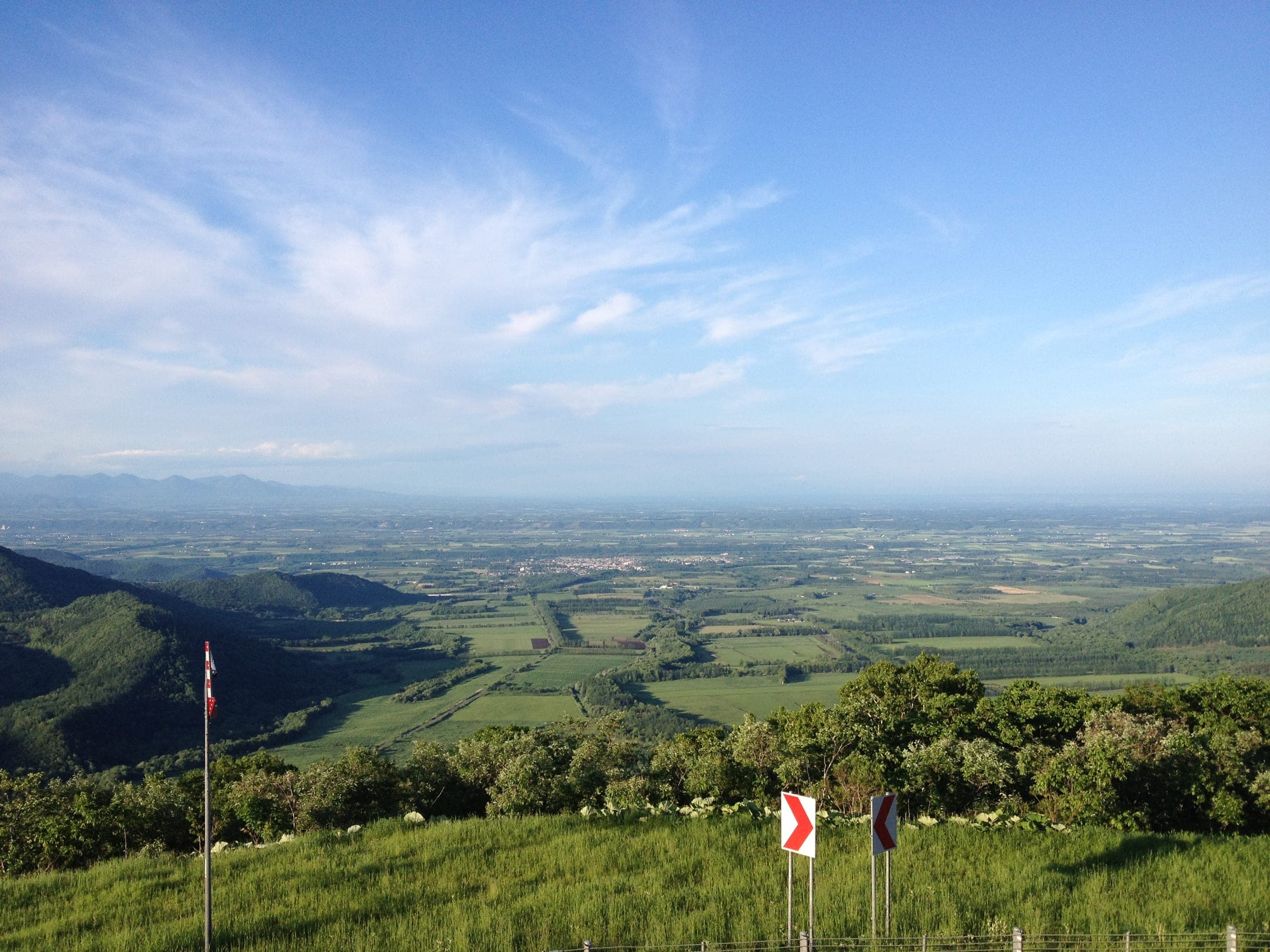 The Tokachi plain stretches toward Obihiro below the forested slopes of Nissho Pass in summer