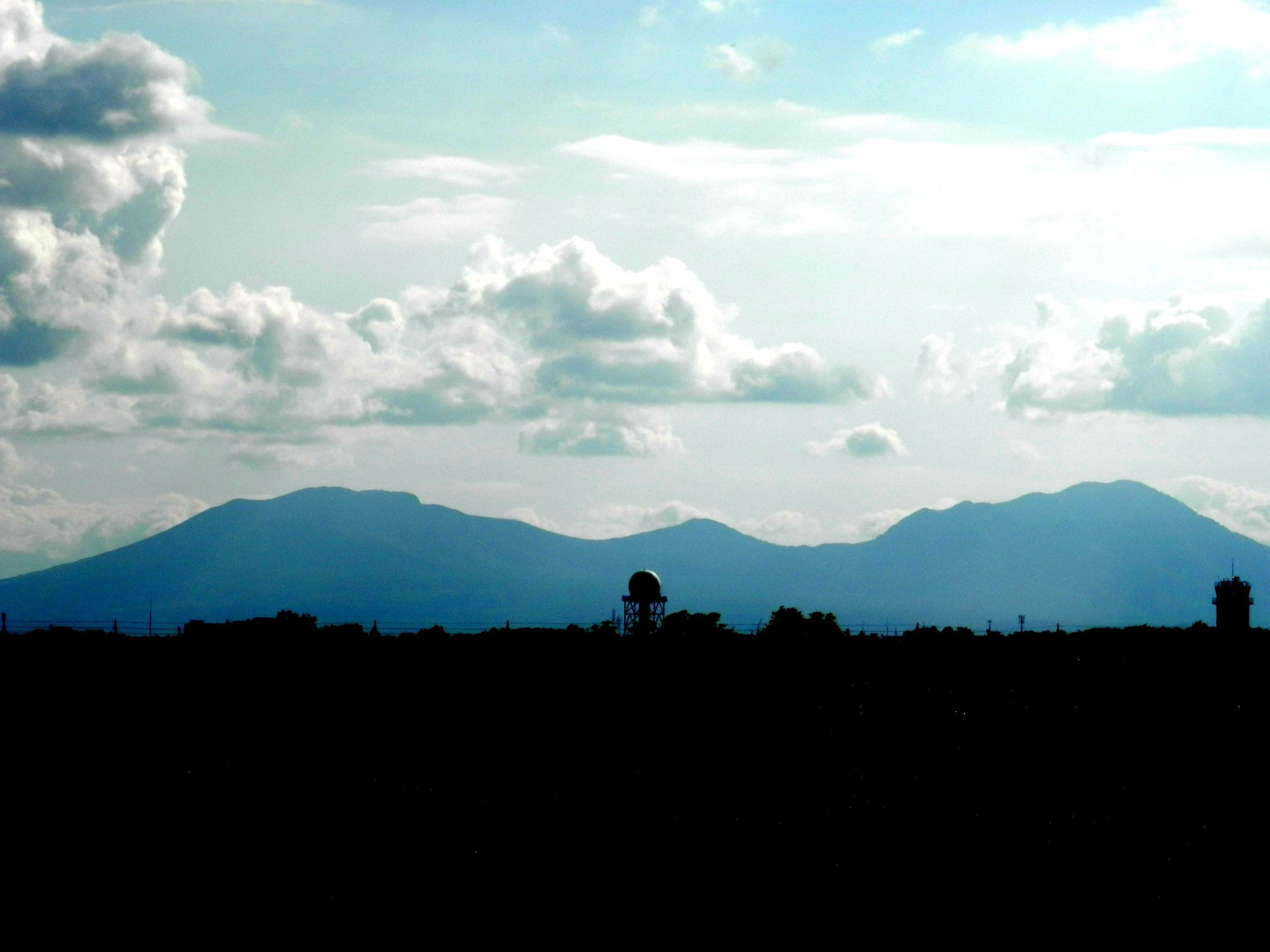Tarumae-zan stands dark against a bright sky beyond New Chitose Airport