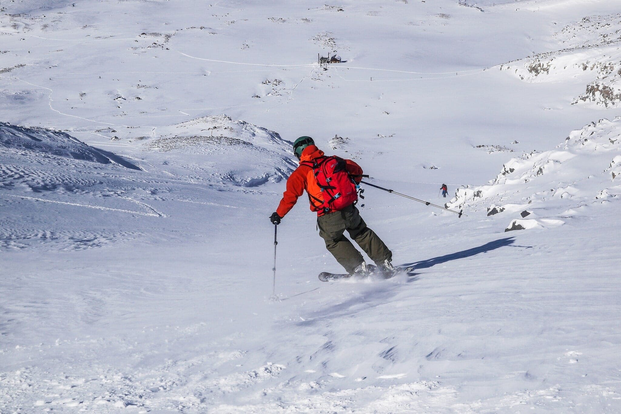 A skier in red descends open snow near the Taisho crater on Maetokachi-dake
