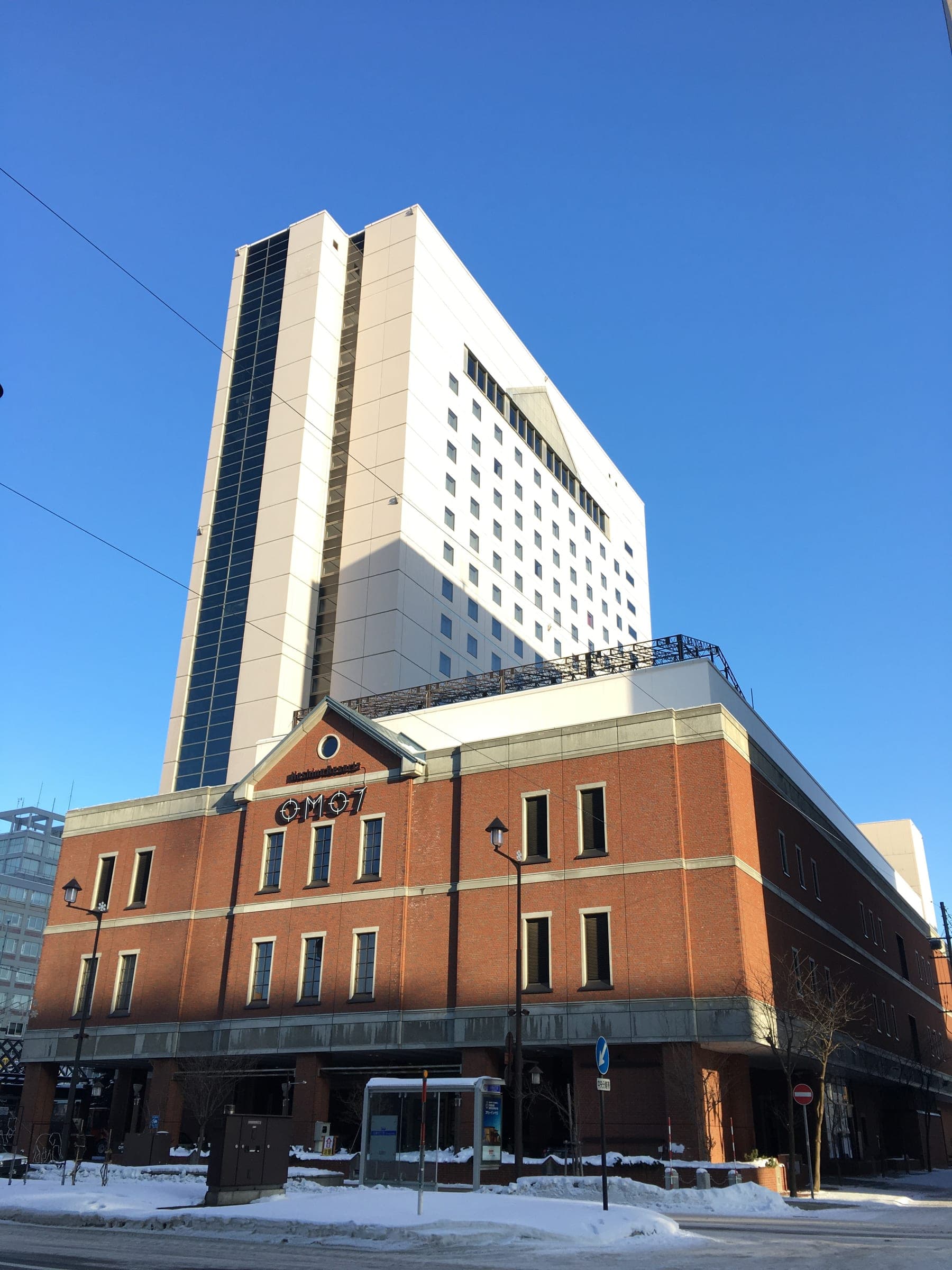 OMO7 Asahikawa hotel tower and its brick entrance in central Asahikawa in January
