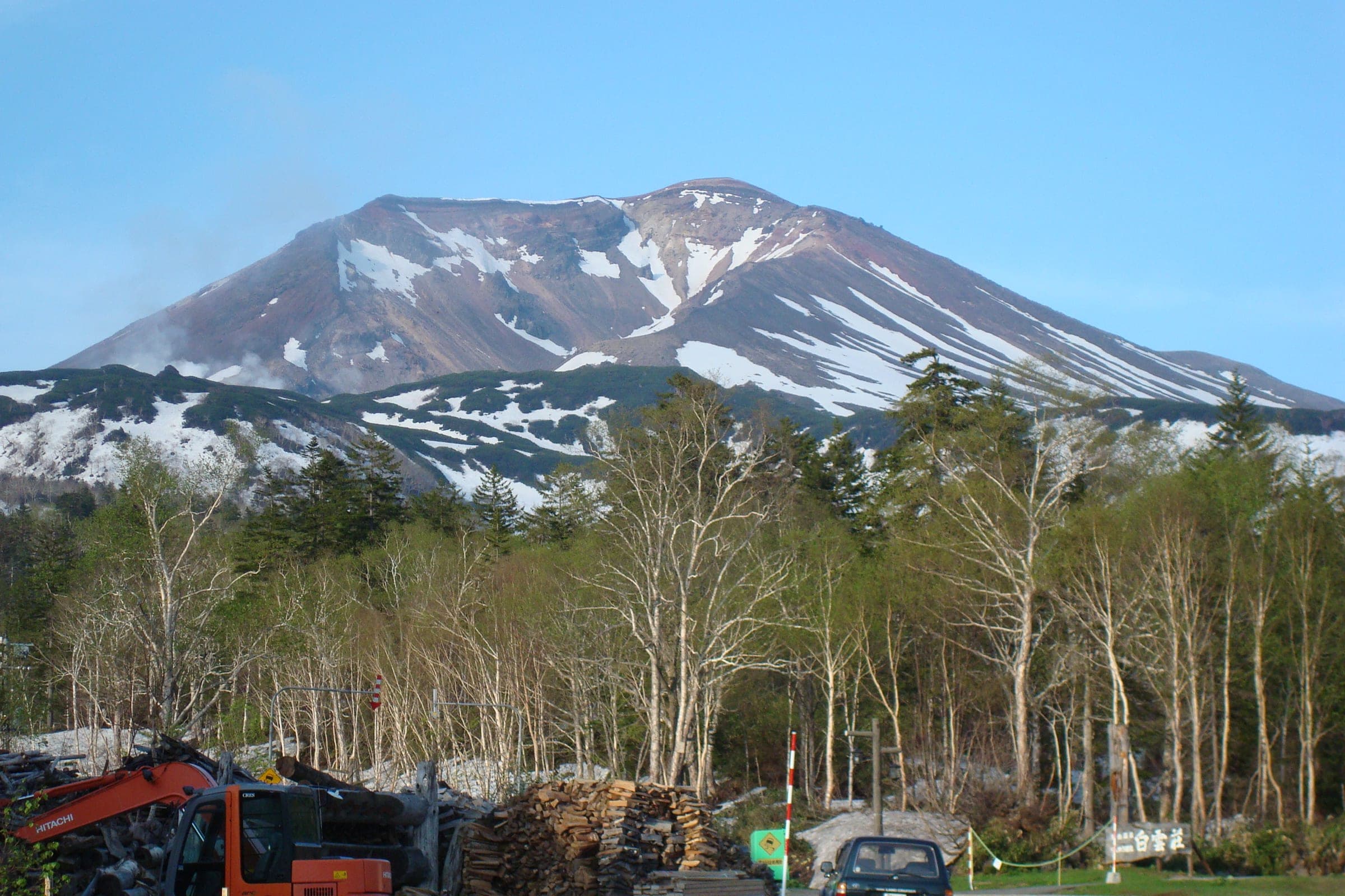 Mt. Asahidake seen across bare birch forest from Asahidake Onsen in spring