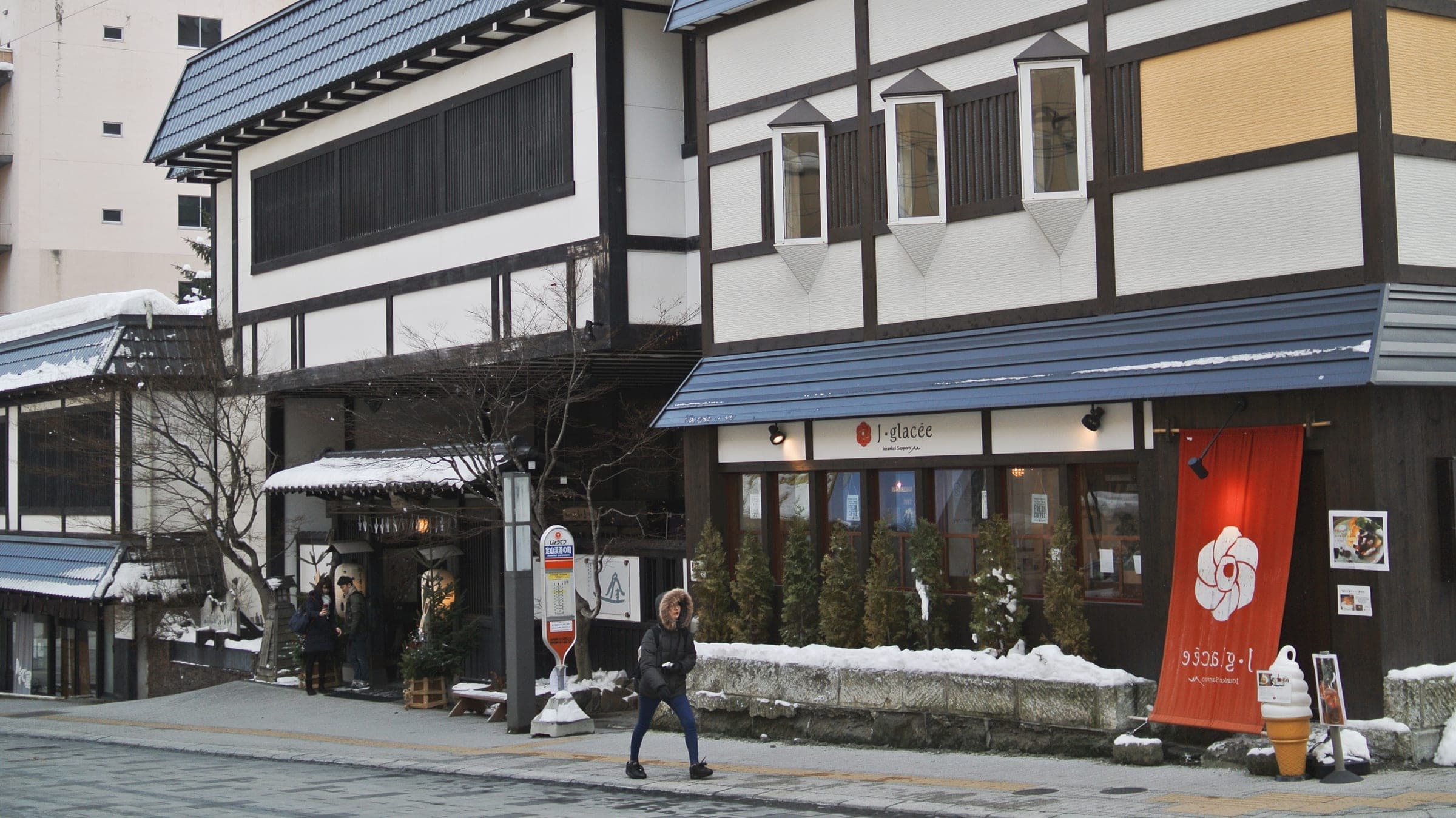 Timber-framed shops face the main street of Jozankei Onsen in winter