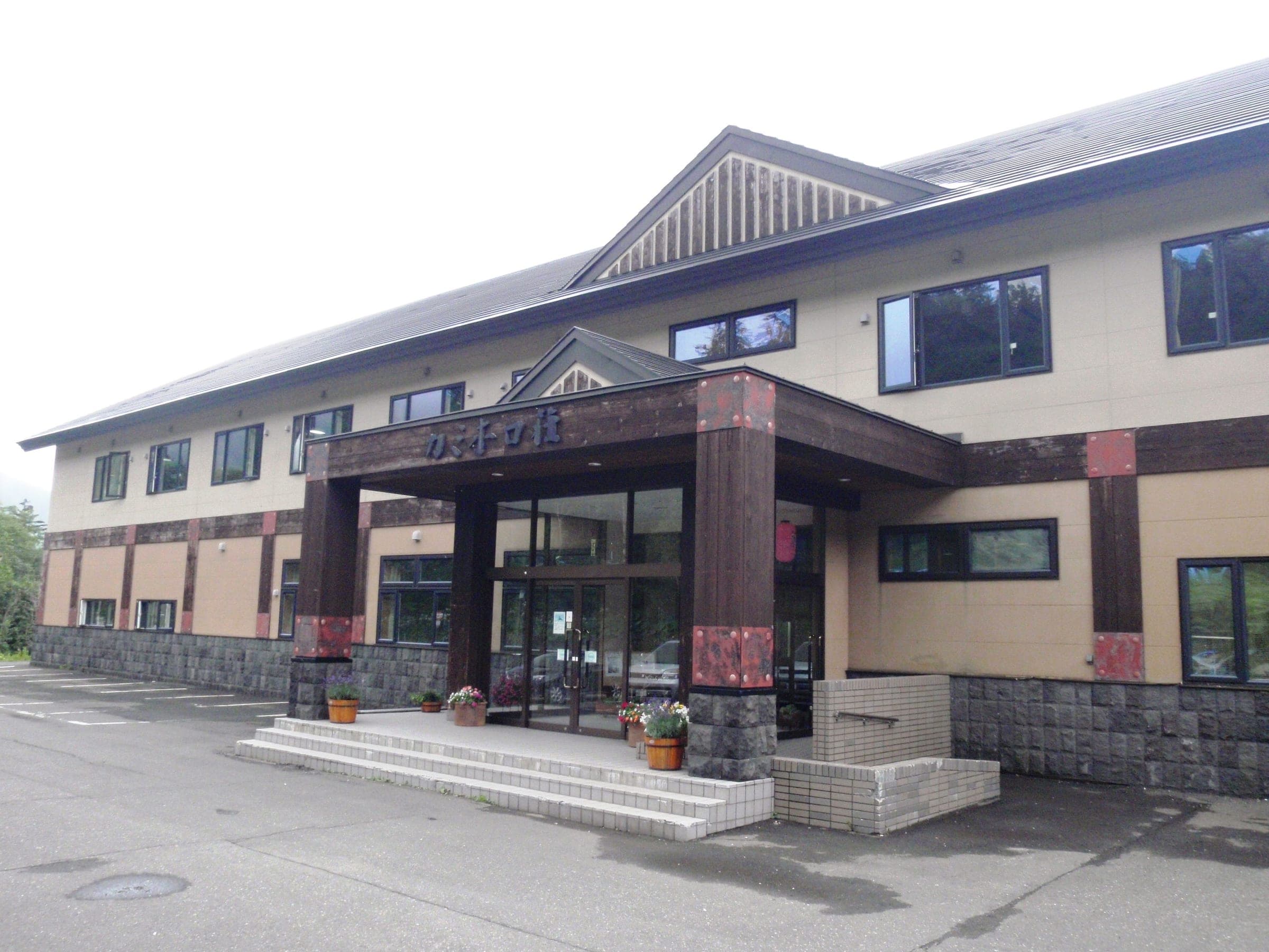 The timber-trimmed entrance of Tokachidake Onsen Kamihoroso in summer