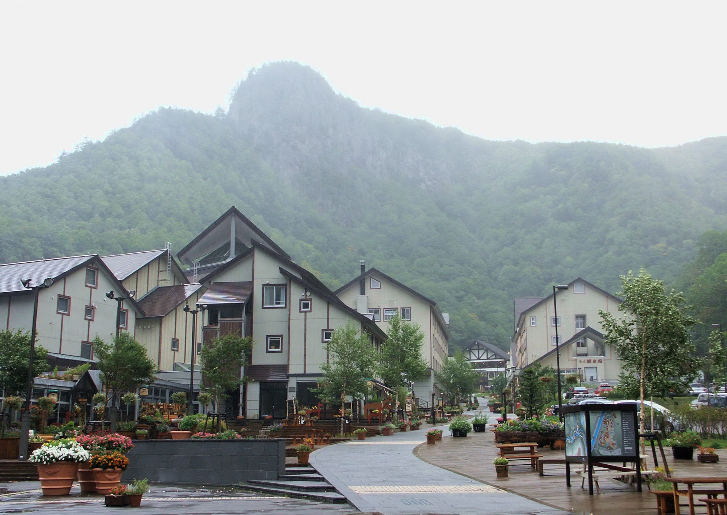 Chalet-style buildings line the main street of Sounkyo village below the gorge walls