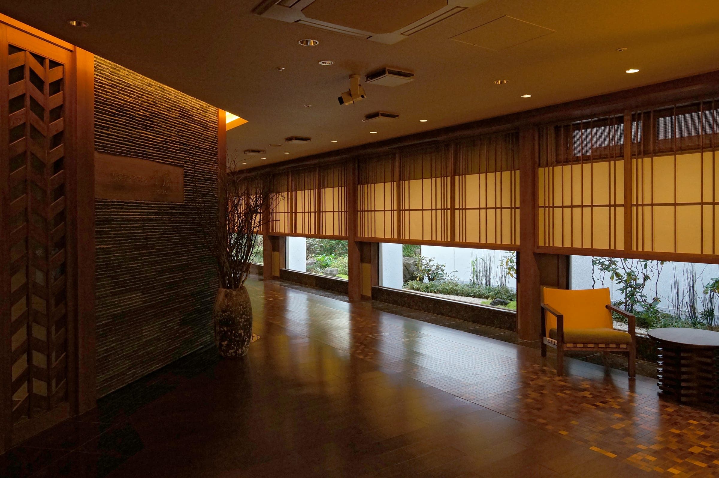 Wood-panelled lobby with tall windows at a Tokachigawa Onsen hotel