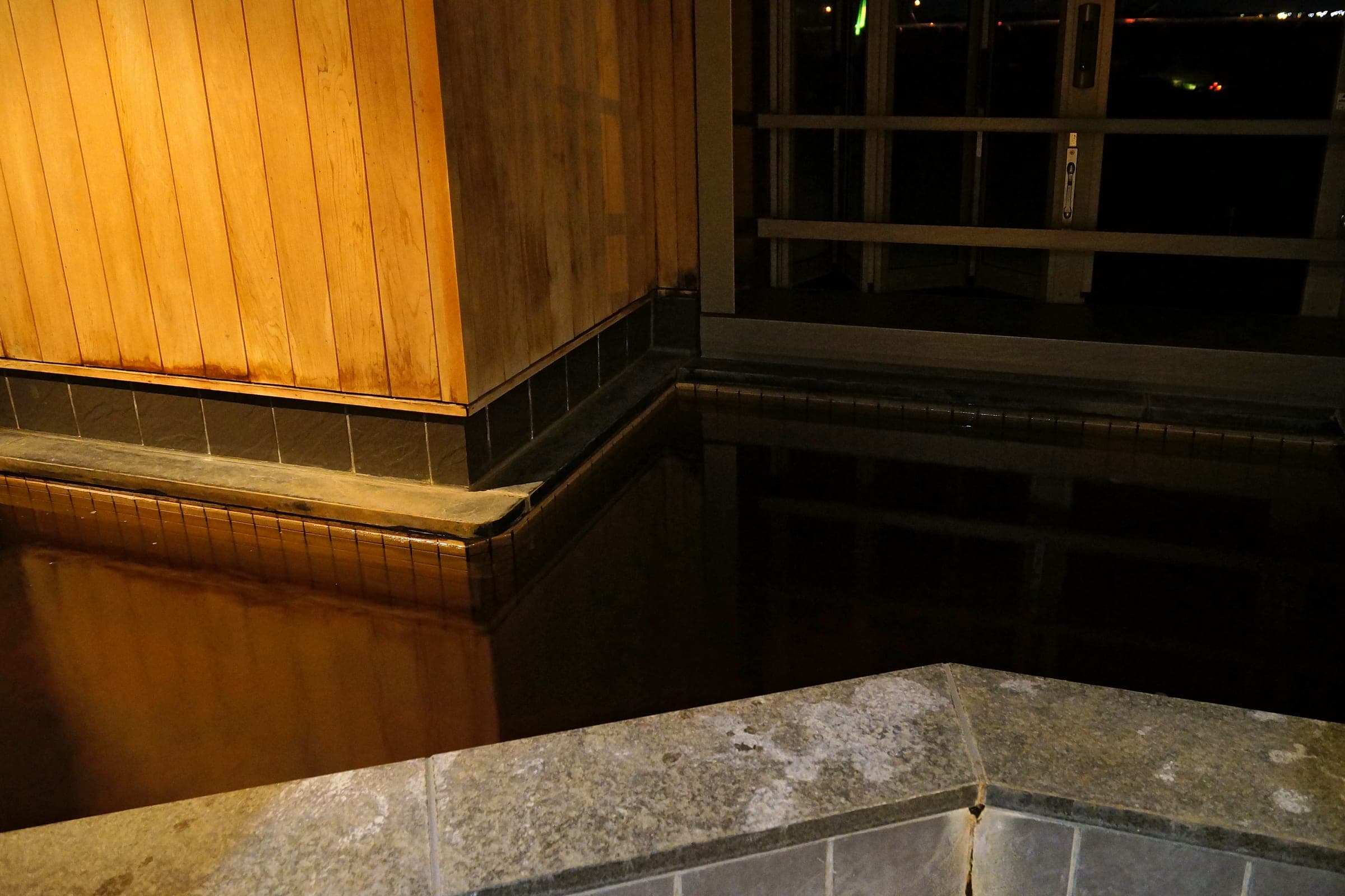 Dark moor water fills a timber-edged bath at Tokachigawa Onsen