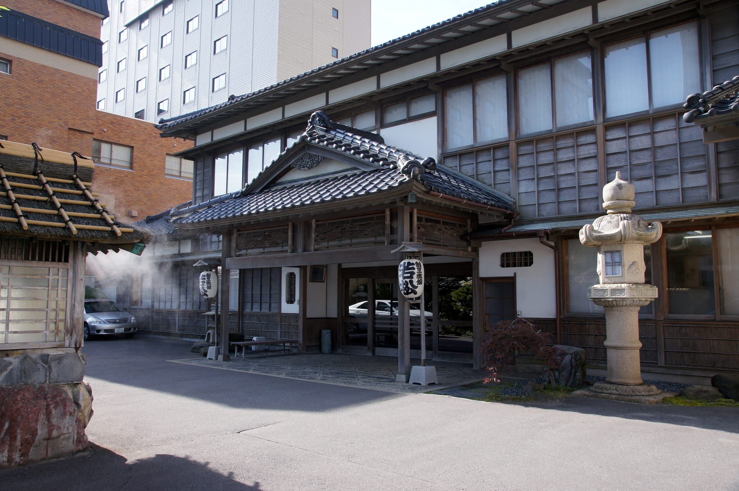 Steam drifts past the tiled entrance of Kappou-ryokan Wakamatsu in Yunokawa Onsen