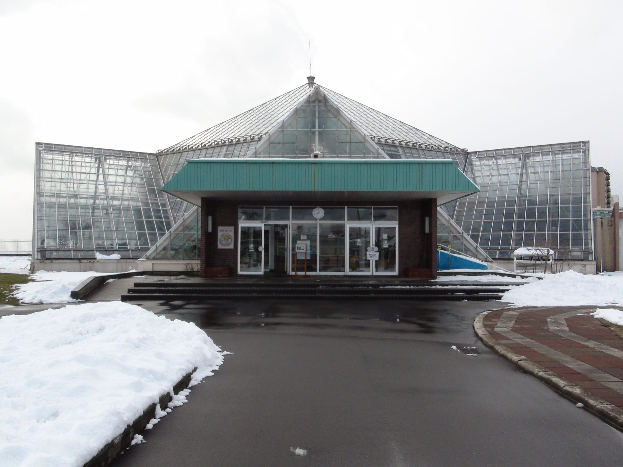 Snow lies around the glass dome of the Hakodate Tropical Botanical Garden in Yunokawa Onsen