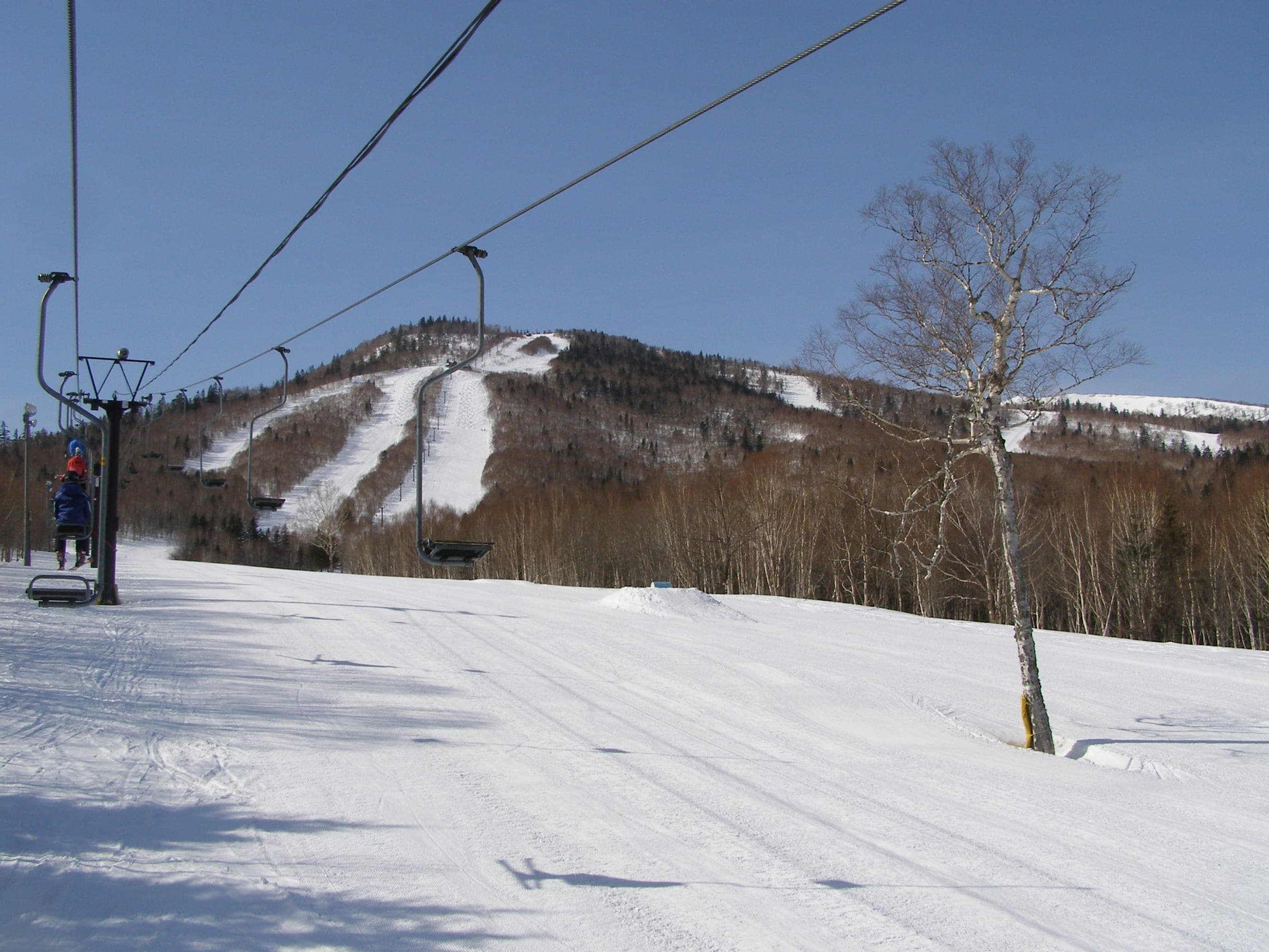 A disused chairlift climbs toward the snowy runs of the old Kita-Taisetsu ski area