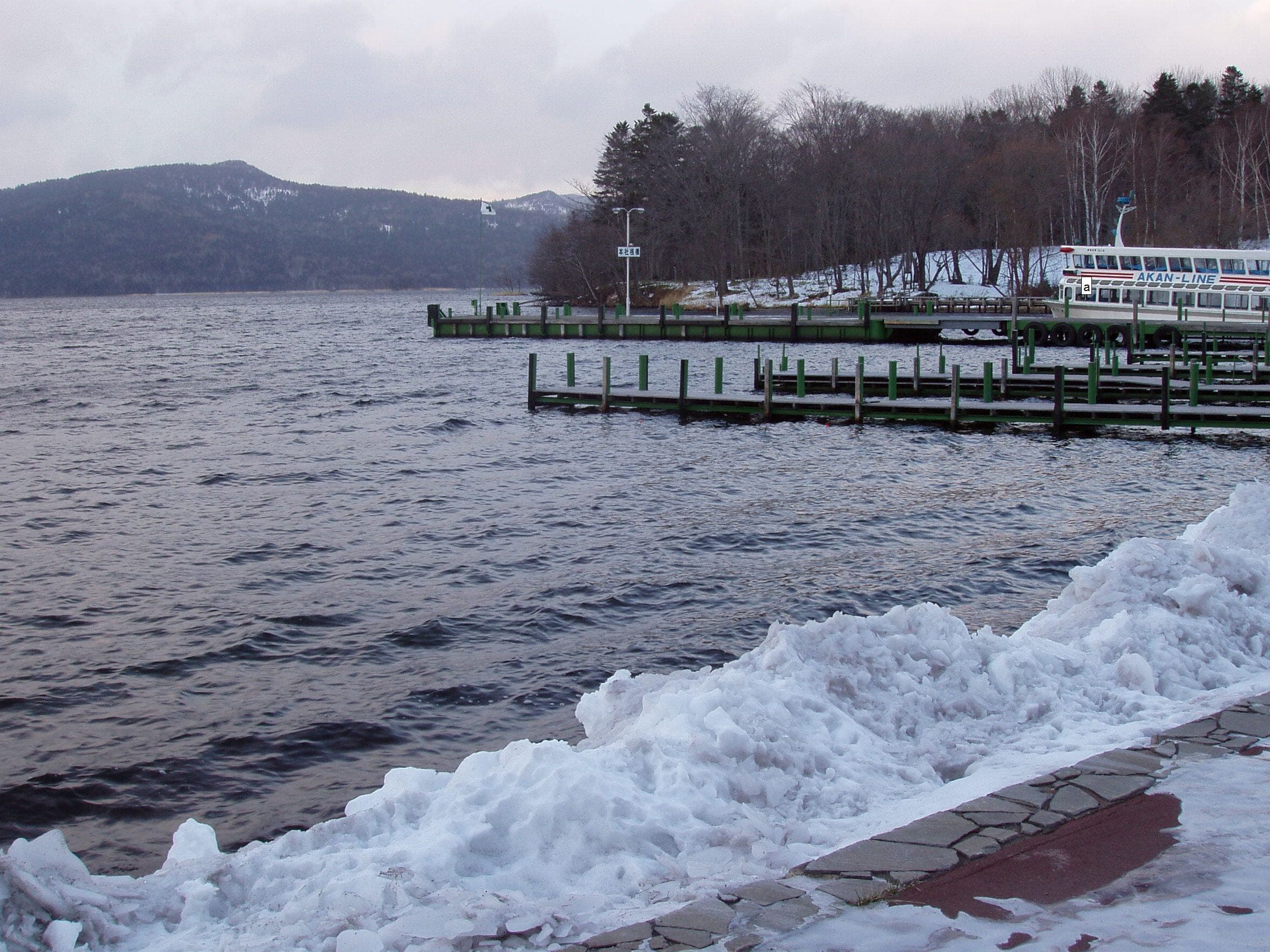 Snow banks the shore of Lake Akan in December, a short walk from the Akan lakeside ski hill