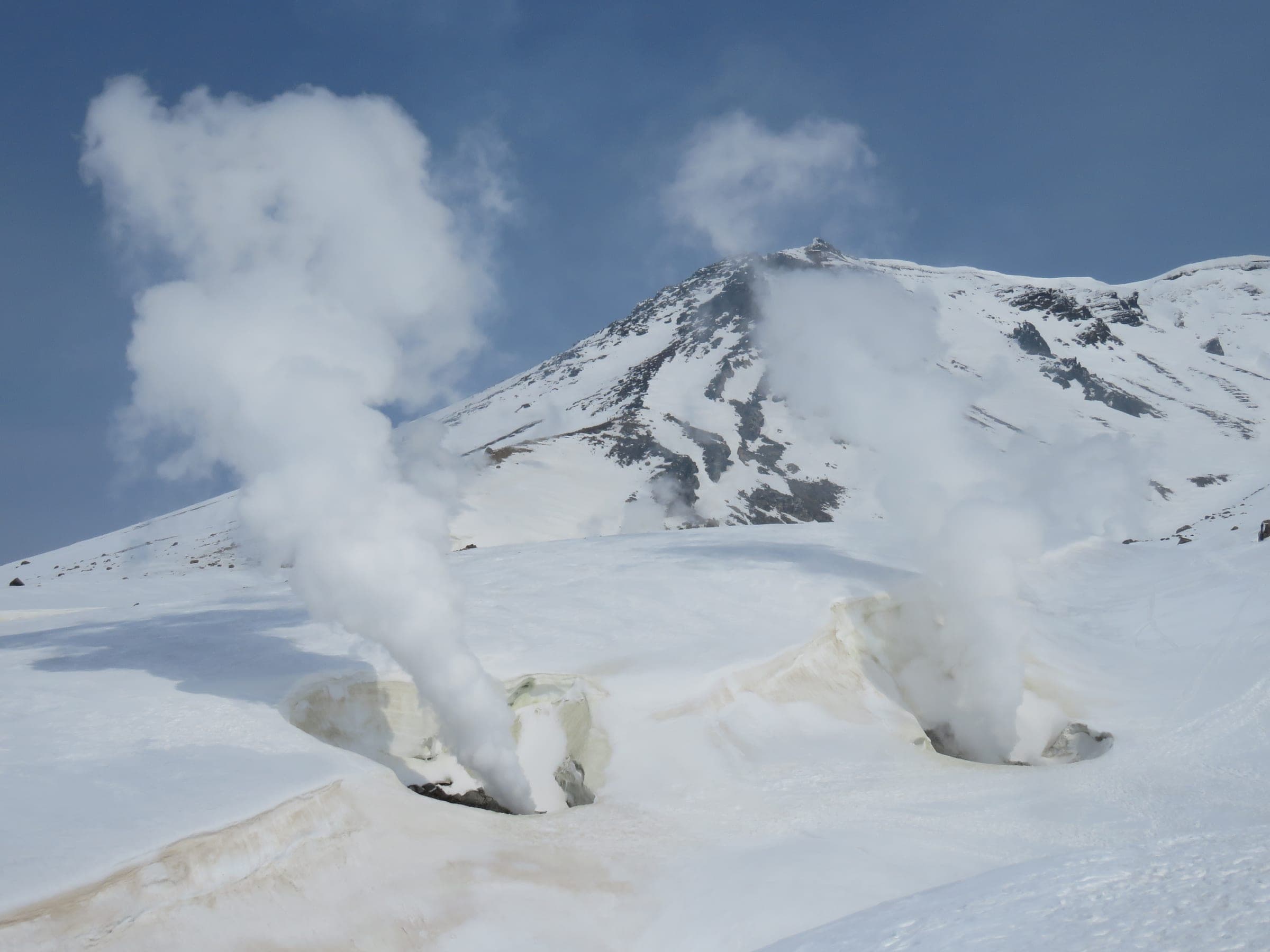 Steam pours from fumaroles in the snow below Asahidake's summit near the top of the ropeway