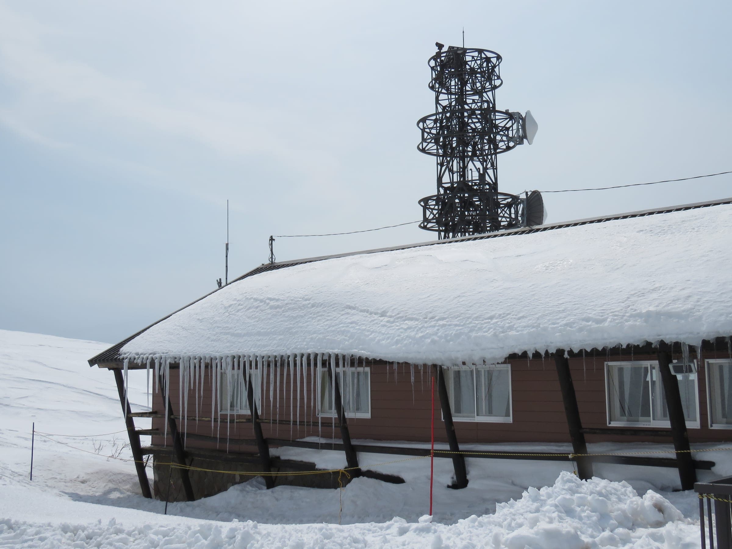 Icicles hang from the snow-loaded roof of the Asahidake Ropeway upper station