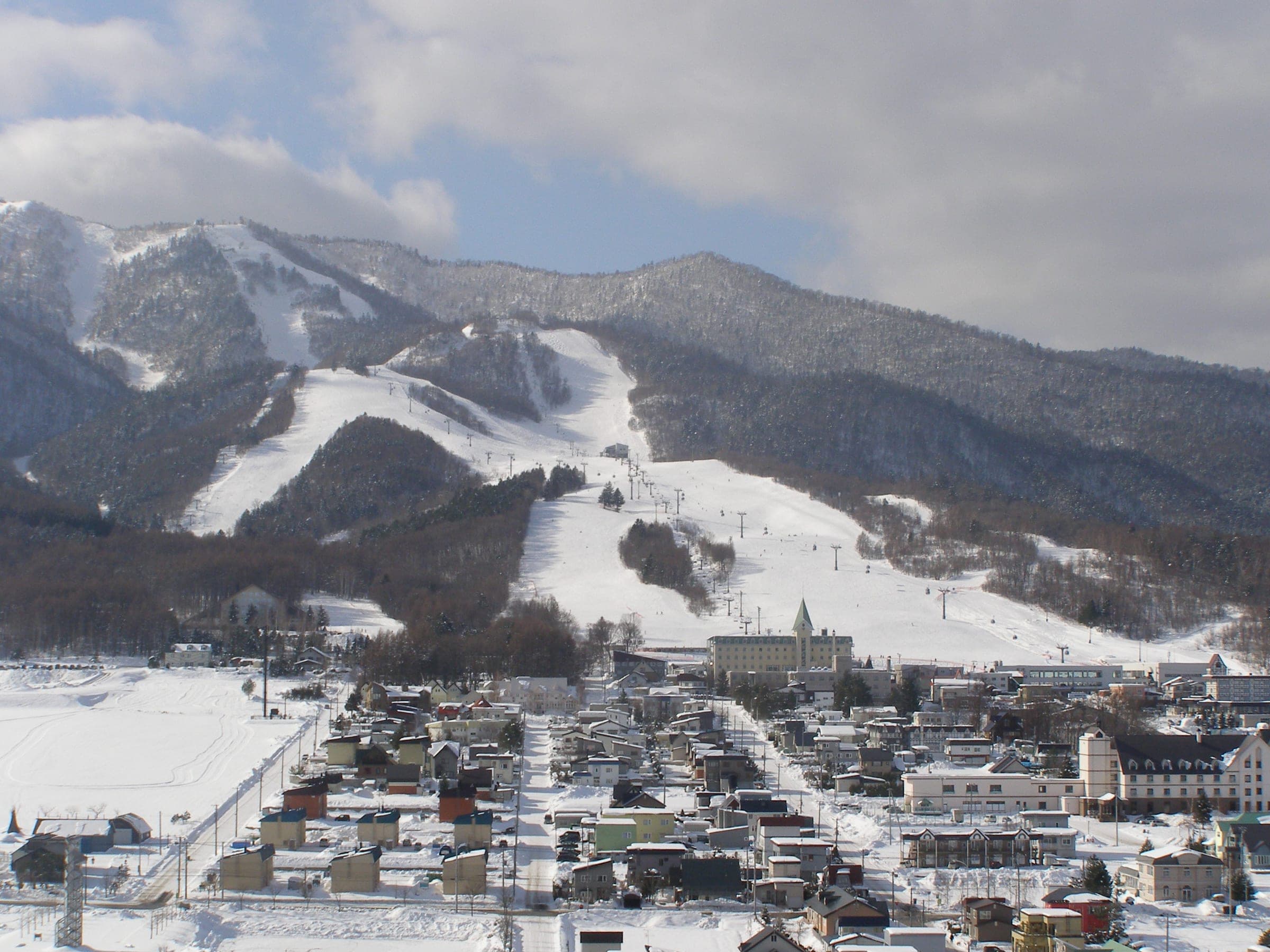 Furano's Kitanomine runs fan out down forested slopes above the snow-covered town