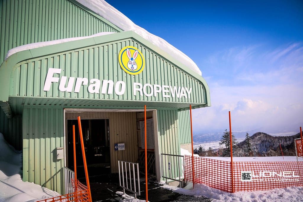 Snow piles high on the roof of the green Furano Ropeway base station