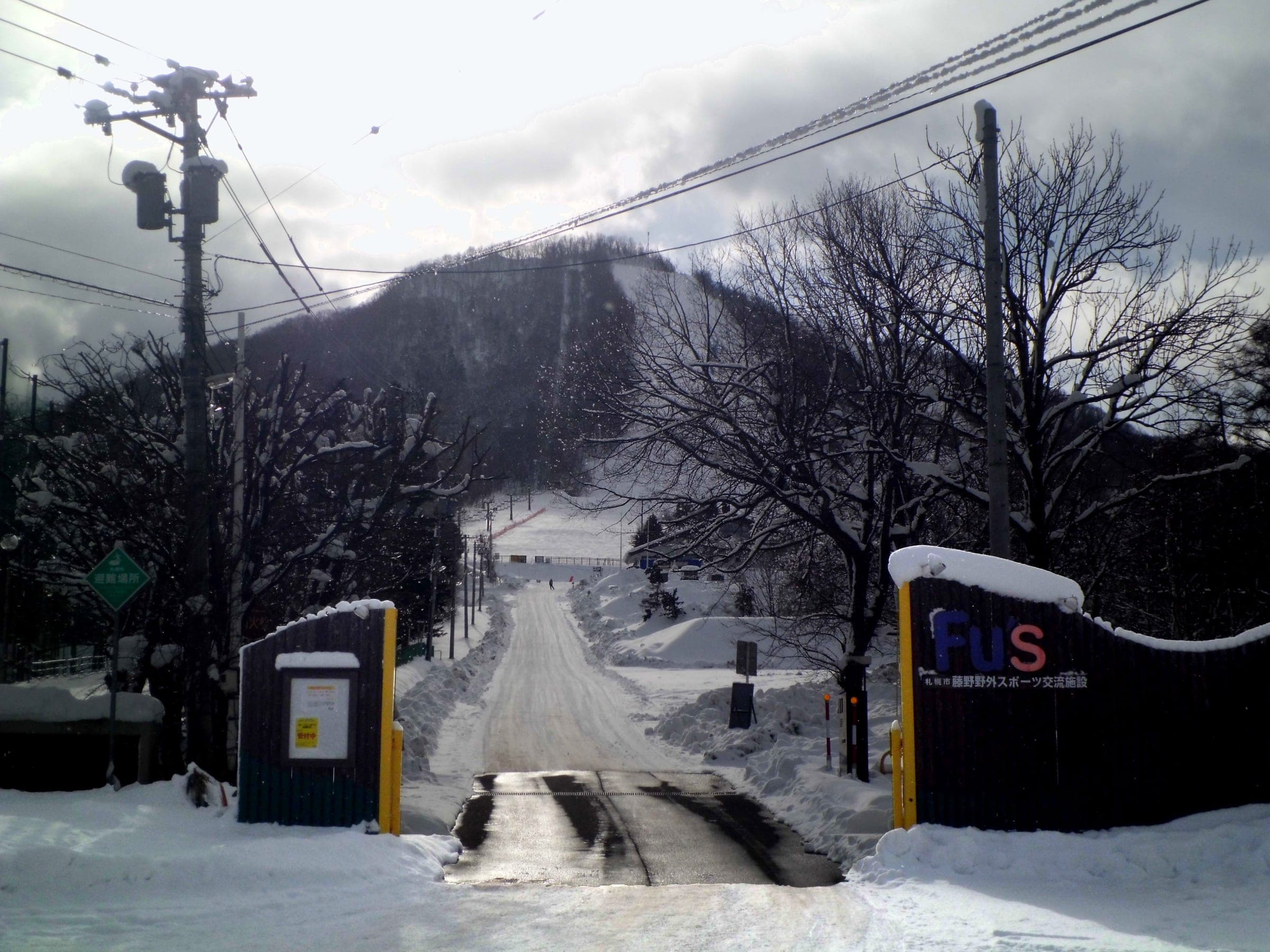 The snowy access road climbs toward the Fu's Snow Area slope on the edge of Sapporo