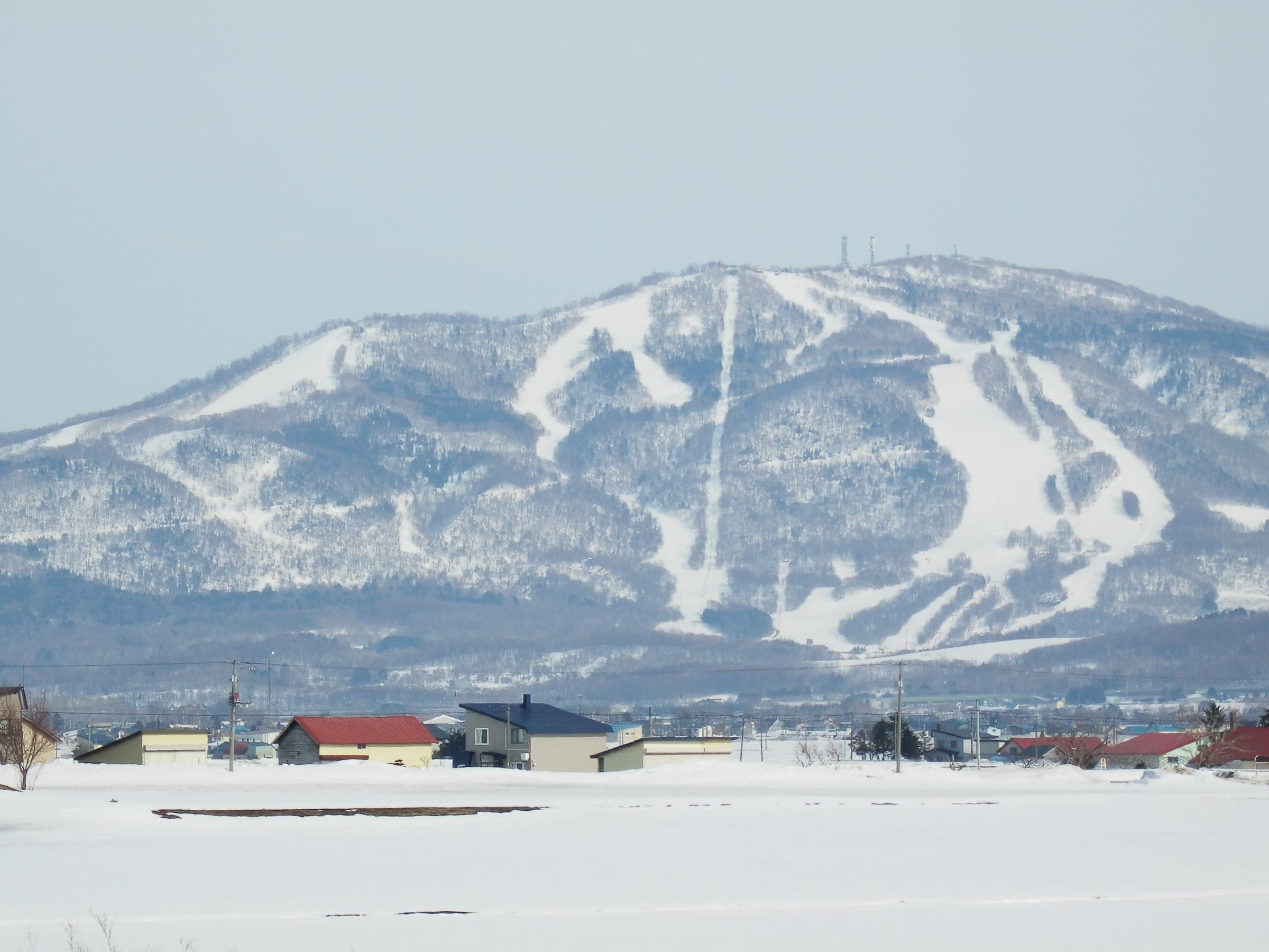 Kamui Ski Links' runs streak the snowy flanks of Kamui-yama above farmland outside Asahikawa