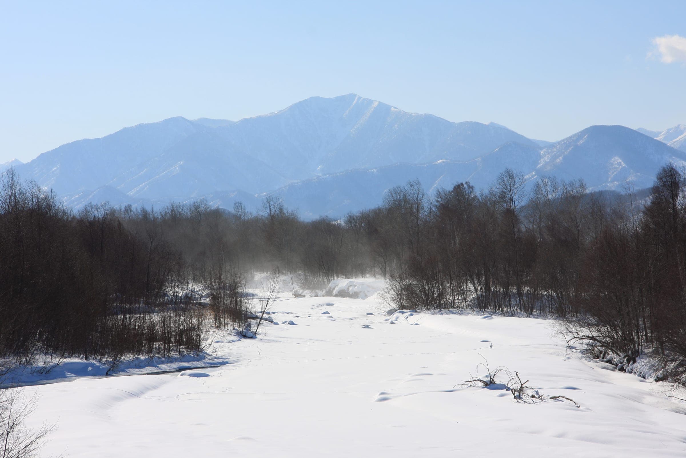 Mt. Tokachi-Poroshiri rises over the frozen Bisei River in Memuro, a few kilometres from the Memuro ski hill