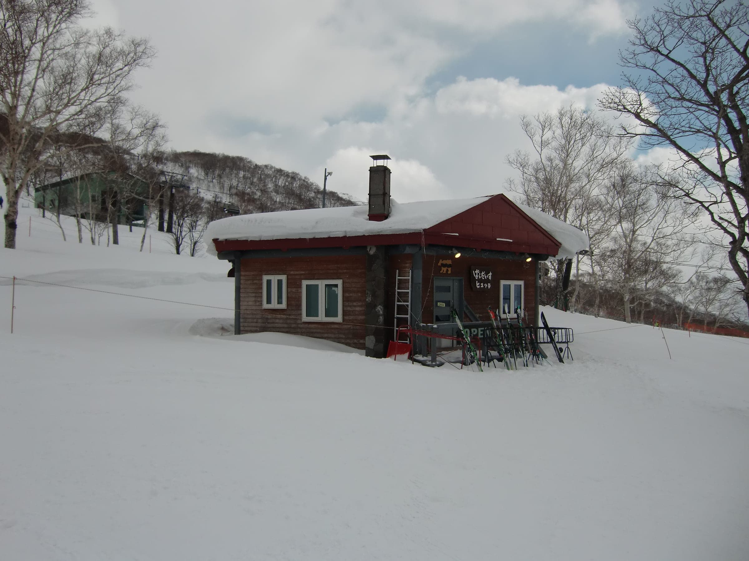 Paradise Hut's log cabin sits in deep snow on the slopes of Niseko Annupuri