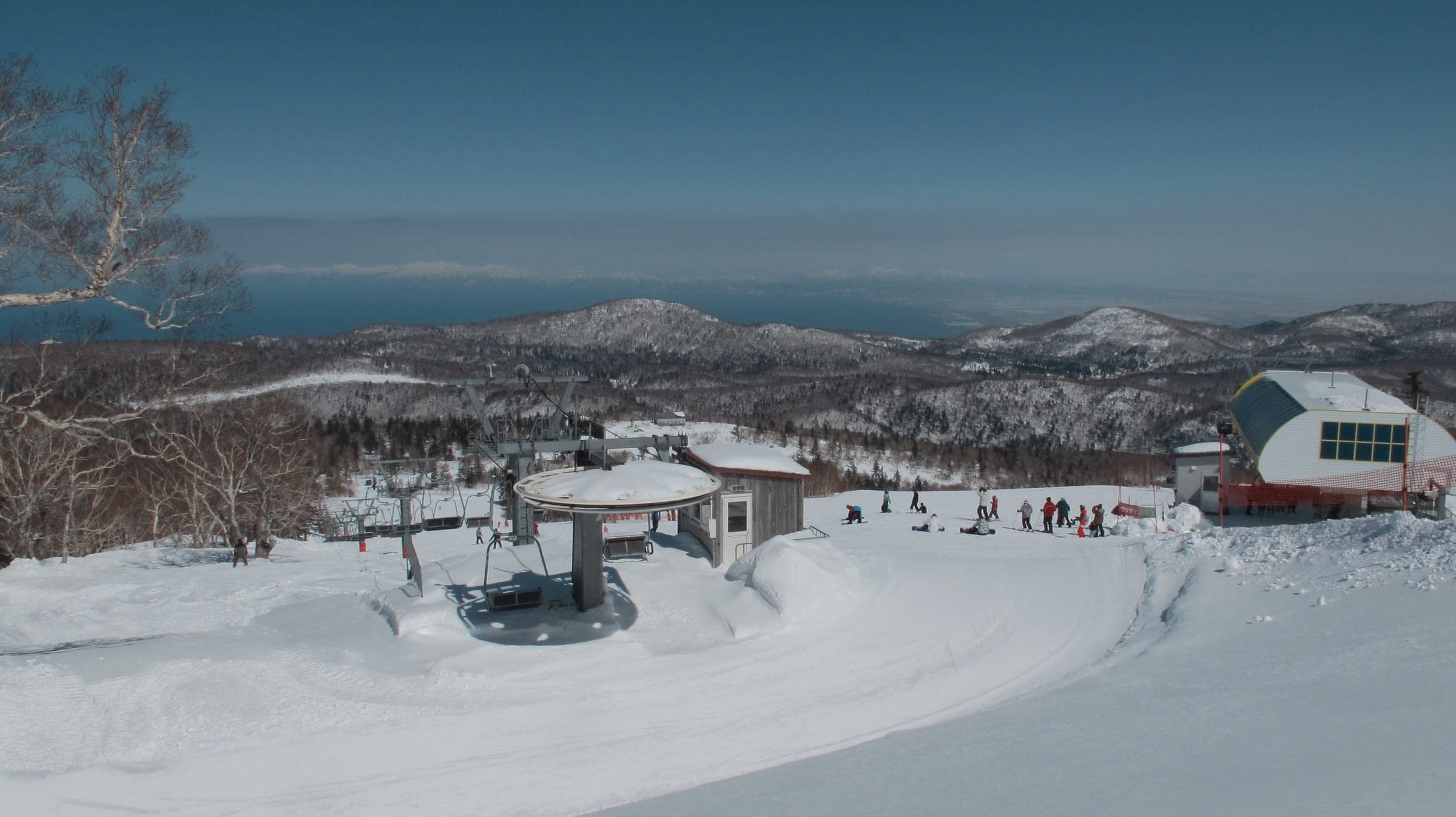 Sapporo Kokusai's snowy slopes look down over forest to the sea beyond Otaru
