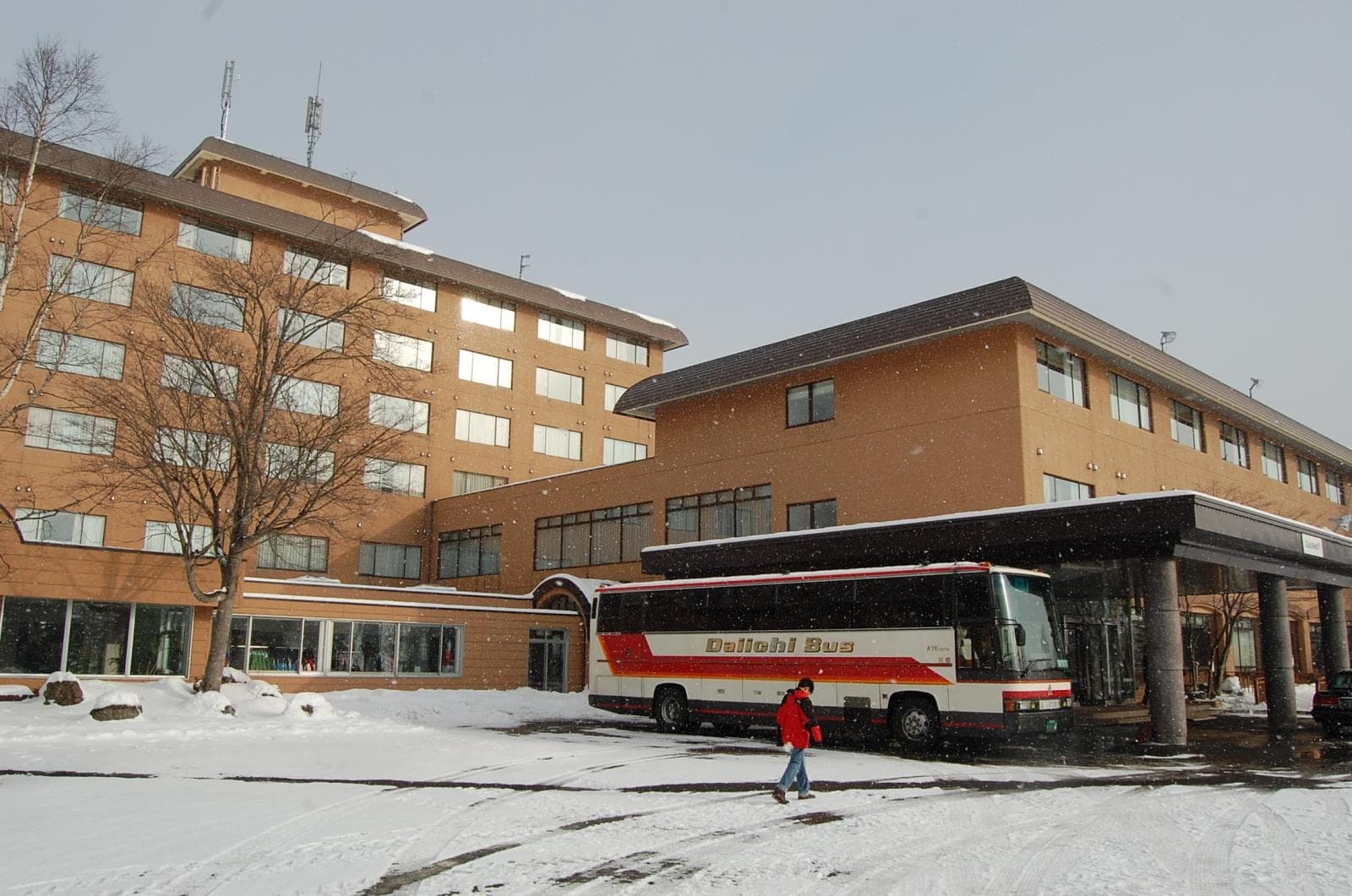 Club Med Sahoro's brick hotel wings and covered entrance with snow on the ground