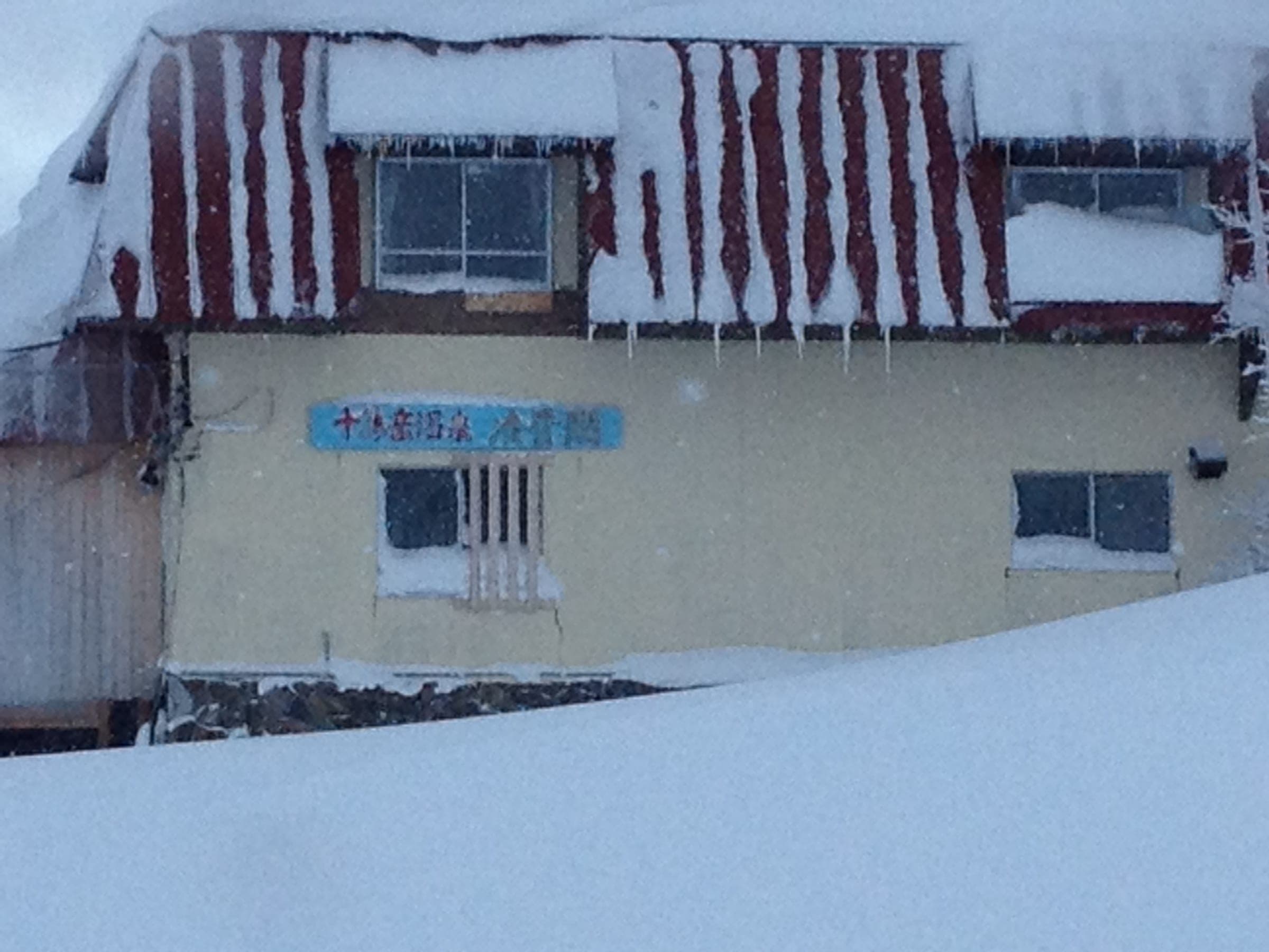 Snow piled to the windows of Ryounkaku at Tokachidake Onsen