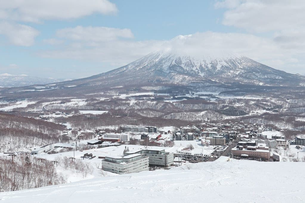 Mt. Yotei rises over the snowy rooftops of Hirafu, seen from the Grand Hirafu slopes