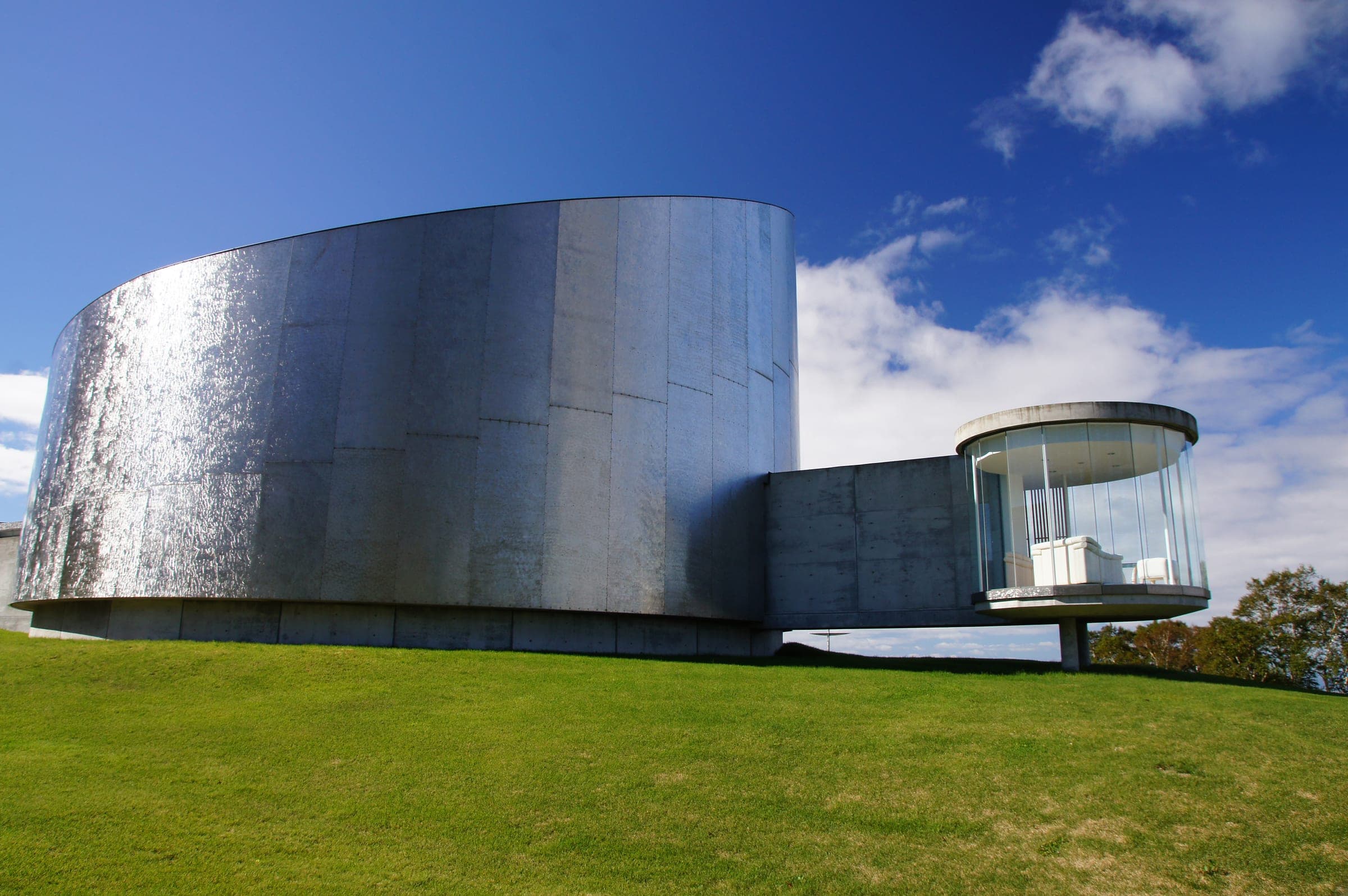 A curved steel pavilion on the lawns of The Windsor Hotel Toya