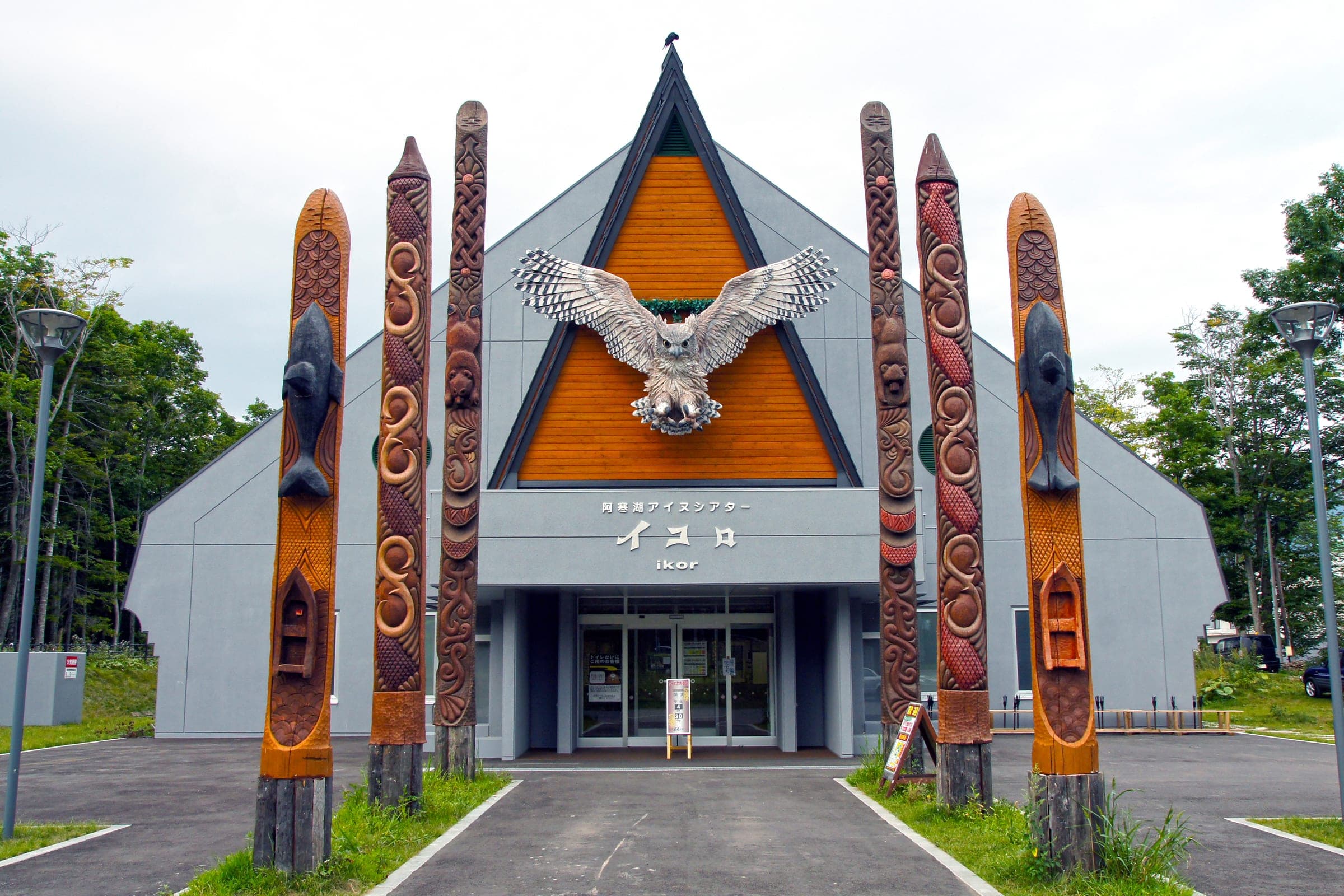 A carved owl spreads its wings on the facade of the Akanko Ainu Theater Ikor