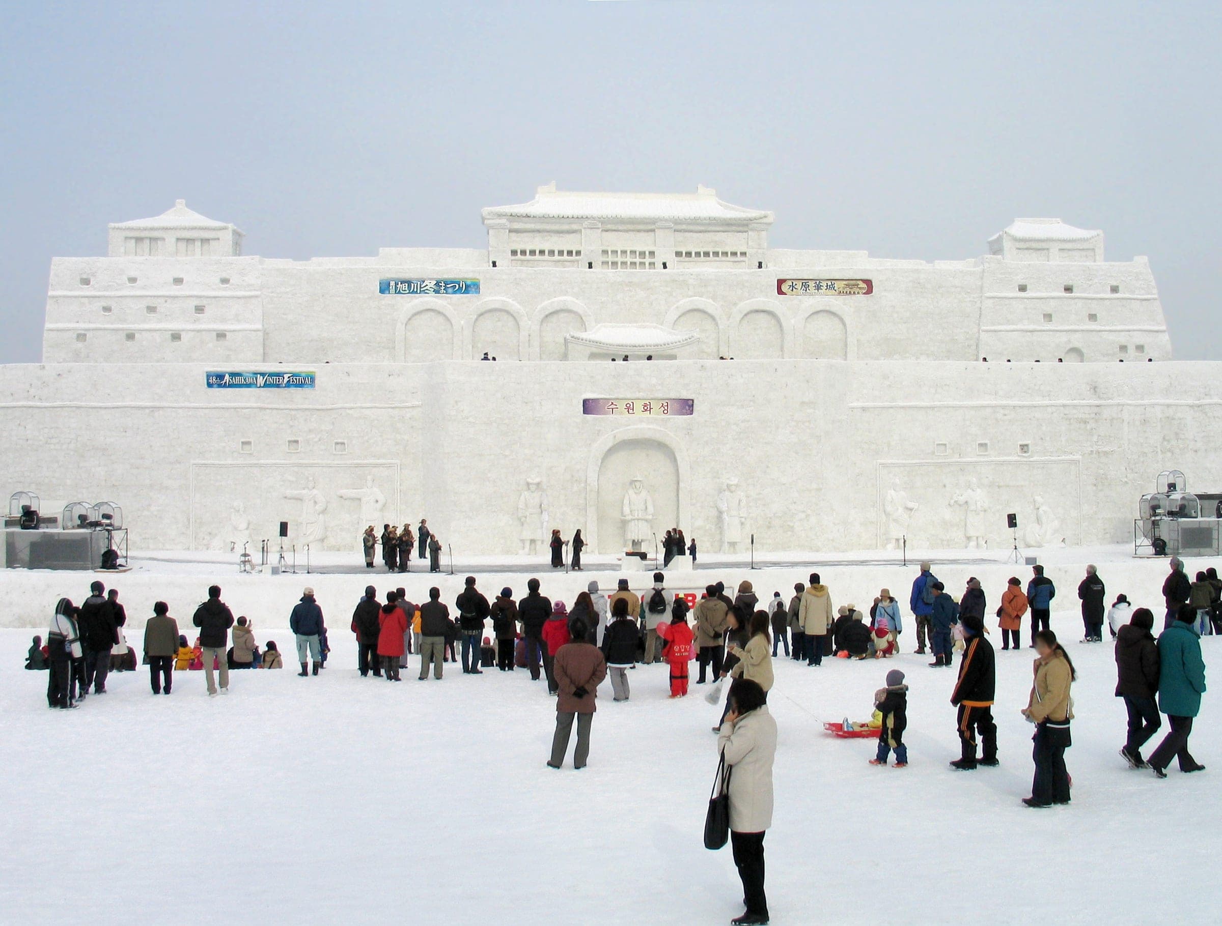 Crowds stand below the giant main snow sculpture at the Asahikawa Winter Festival