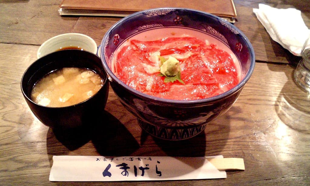 A beef bowl with miso soup on a Kumagera chopstick sleeve in Furano