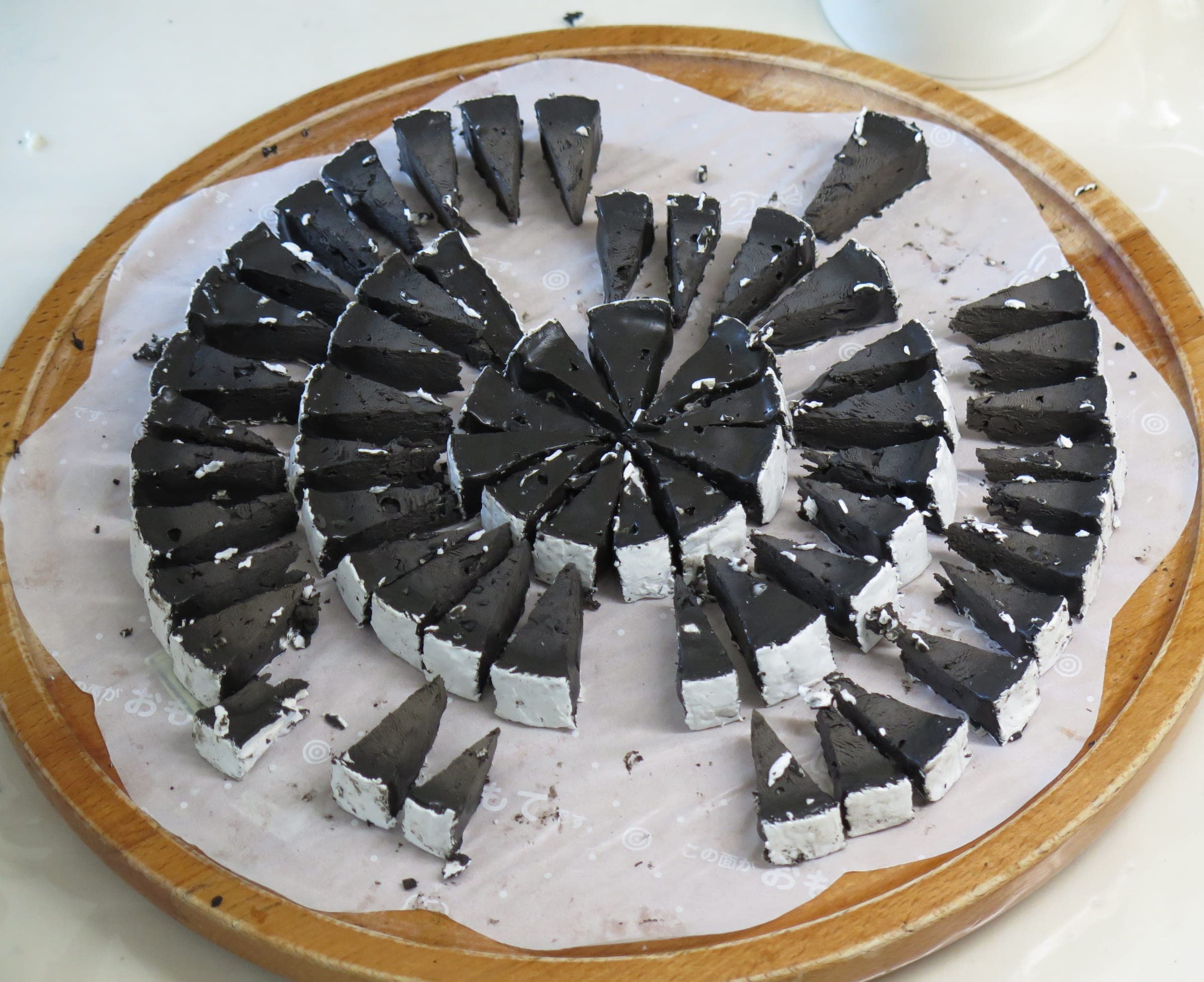Wedges of squid-ink black cheese laid out at the Furano Cheese Factory