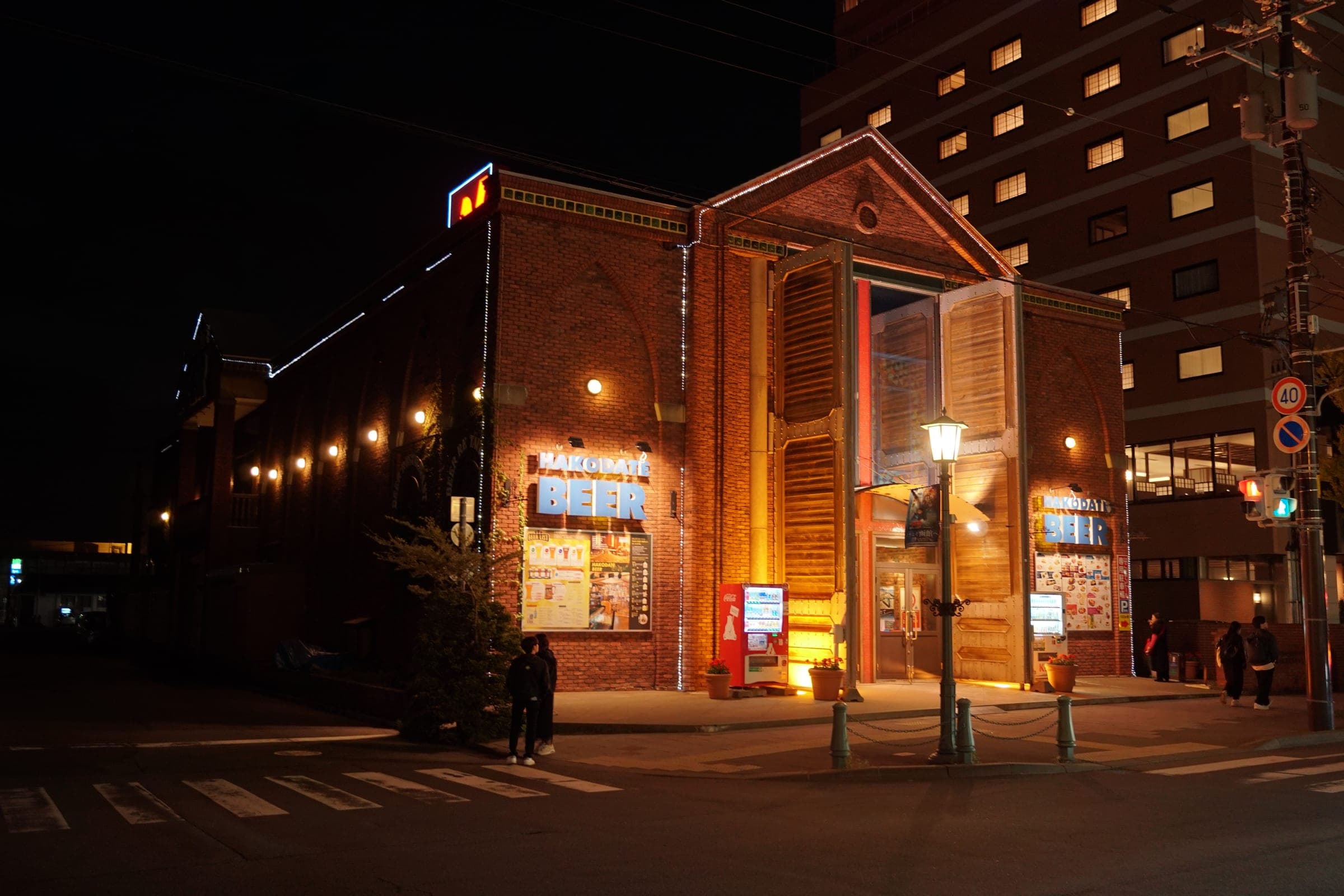 The brick Hakodate Beer brewpub lit up at night