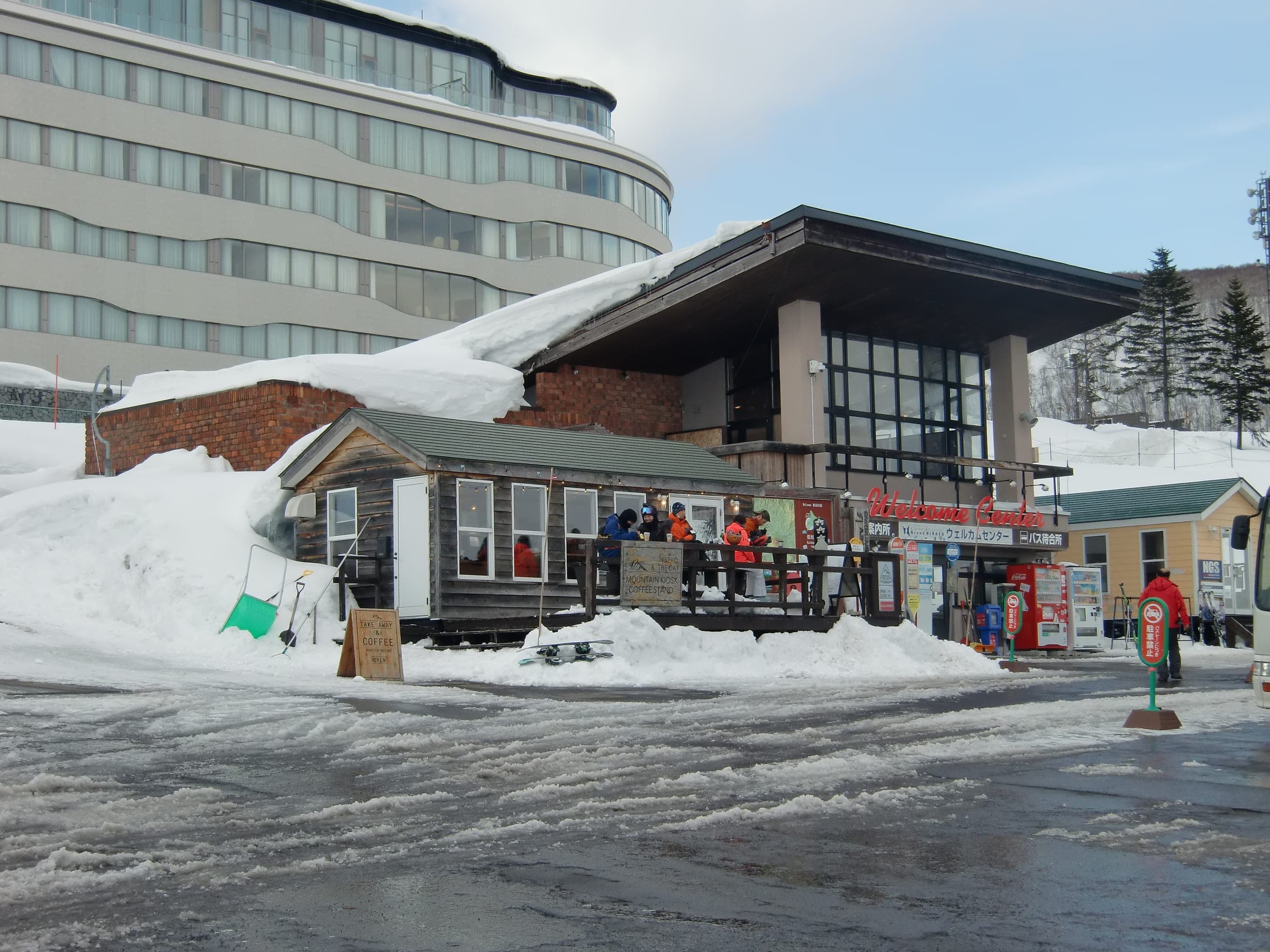 Banks of snow surround the gabled Grand Hirafu Welcome Center and its tall windows