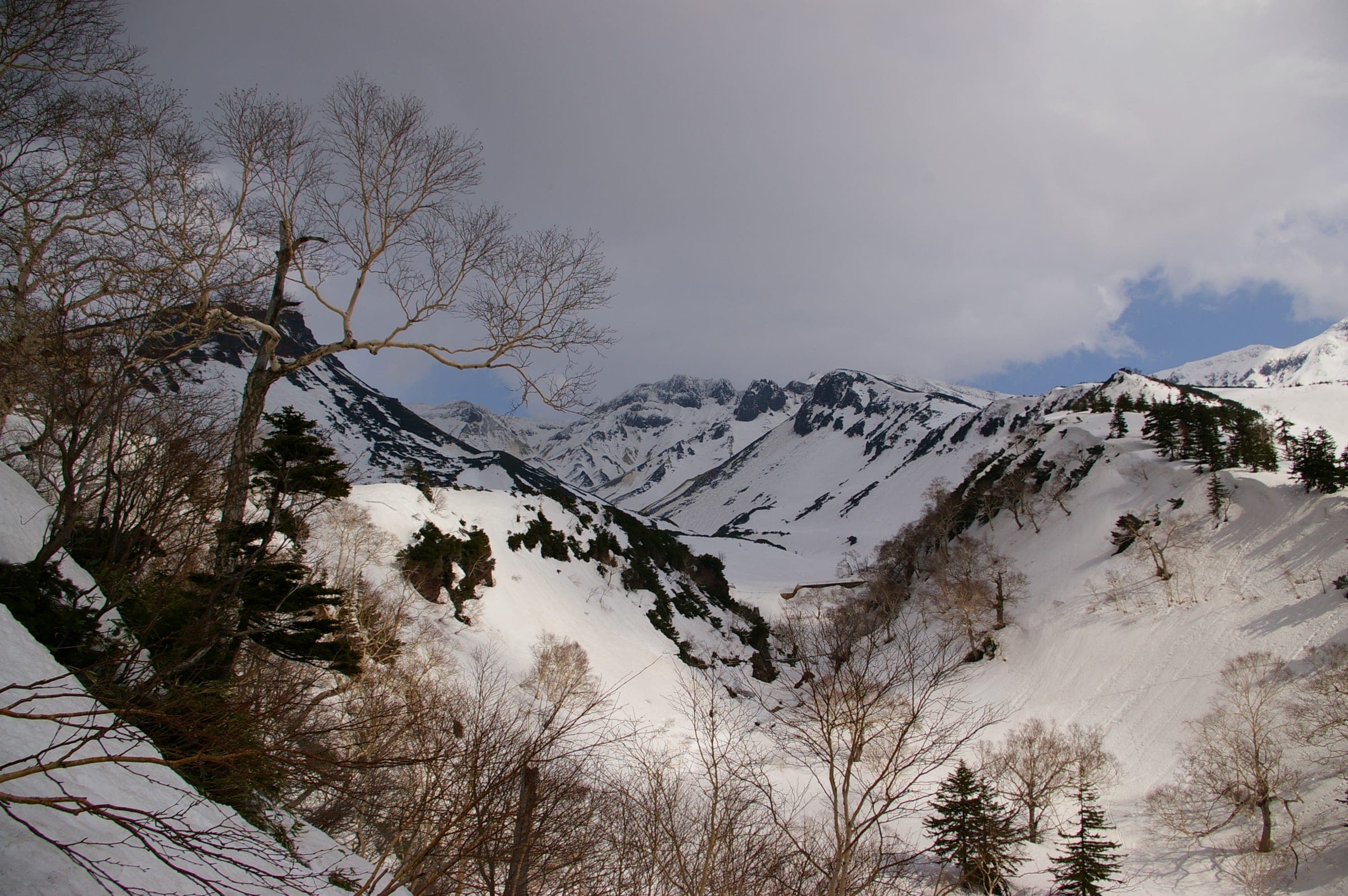 Snow fills the gullies of the Tokachidake range above Tokachidake Onsen