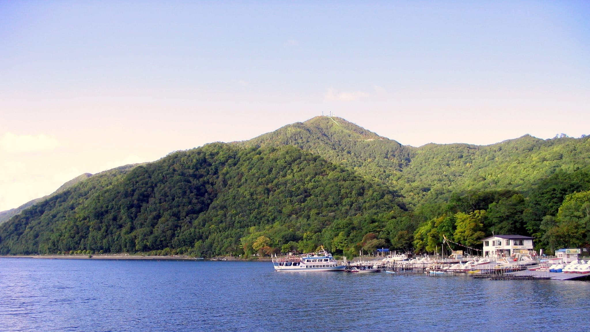 Mt. Monbetsu rises above the shore of the onsen village on Lake Shikotsu