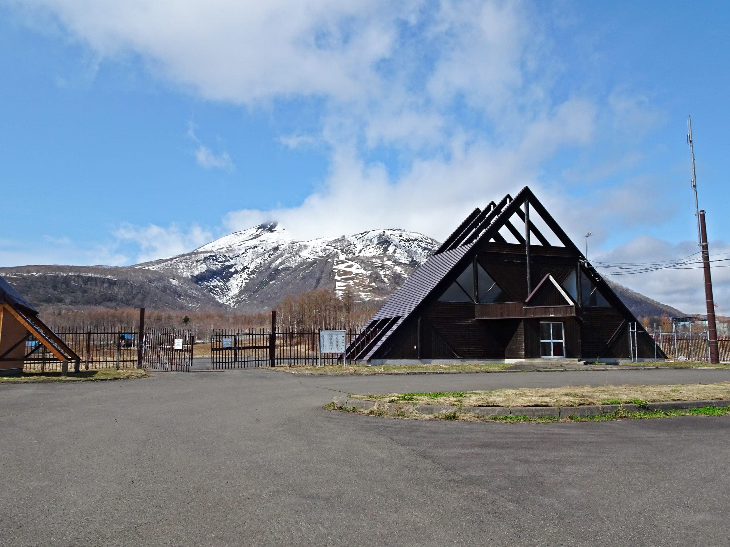 The angular Niseko heliport building below the snow-capped Niseko Annupuri
