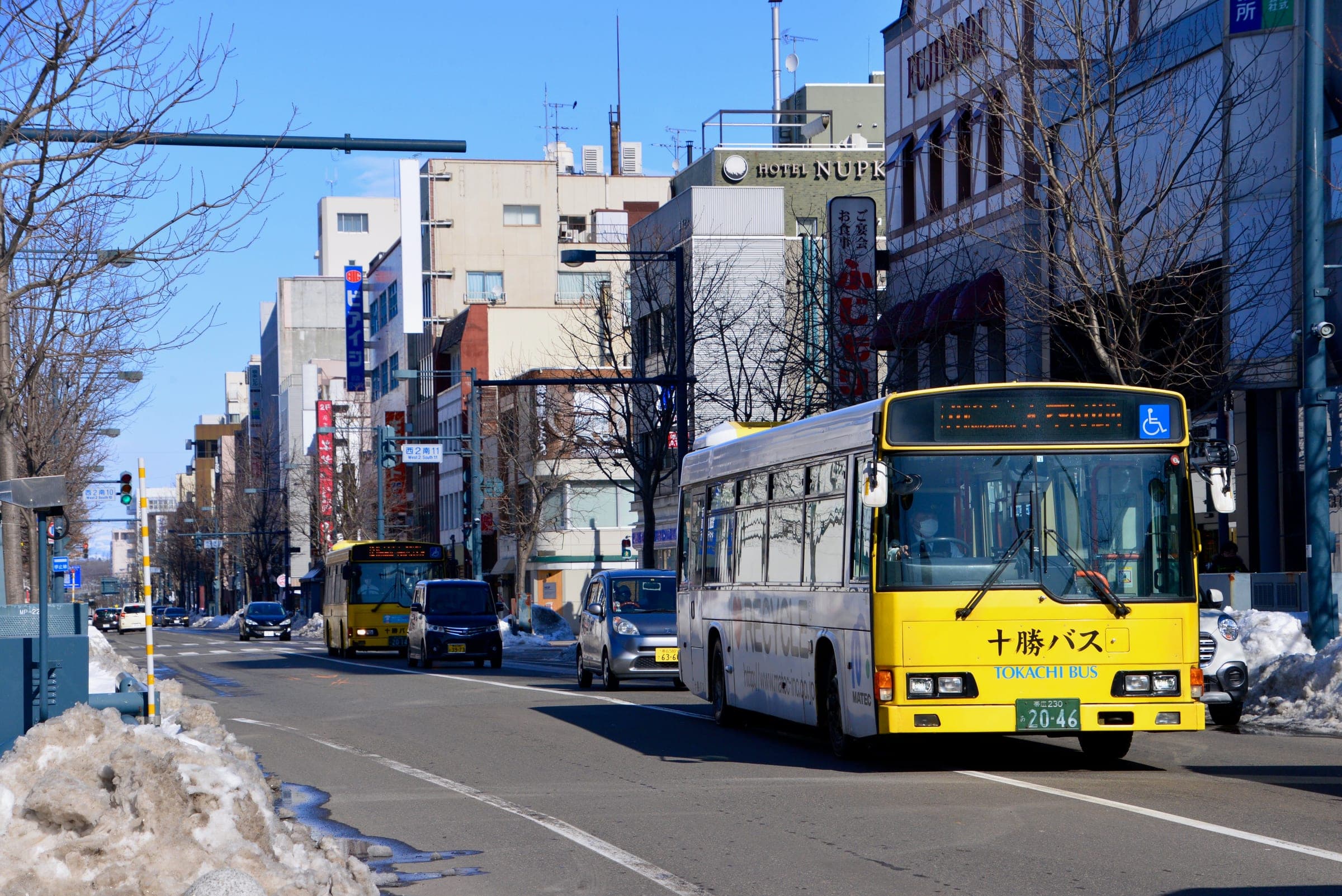 A Tokachi bus heads down Nishi 2-jo street in central Obihiro past banks of snow