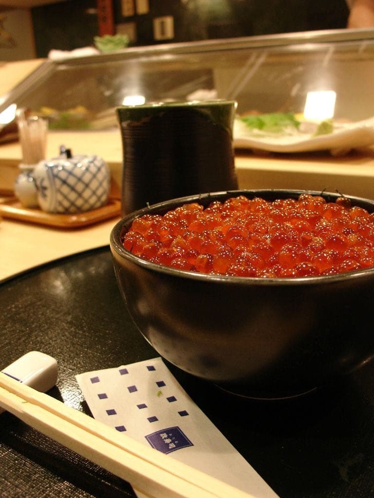 A bowl heaped with salmon roe on the counter at Masazushi in Otaru
