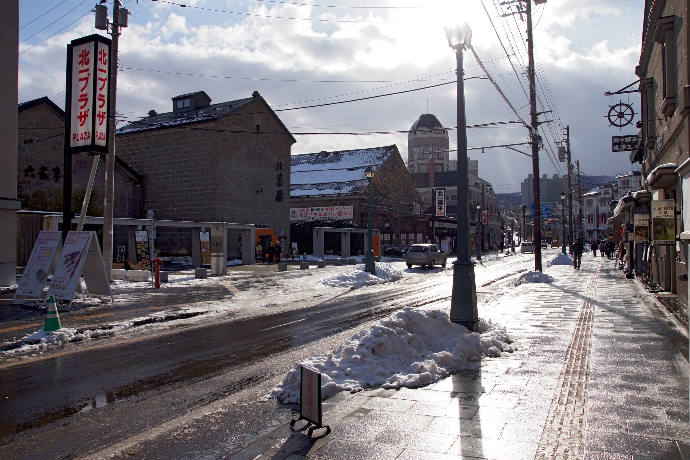 Meiji-era stone shopfronts line Sakaimachi Street in Otaru after snow