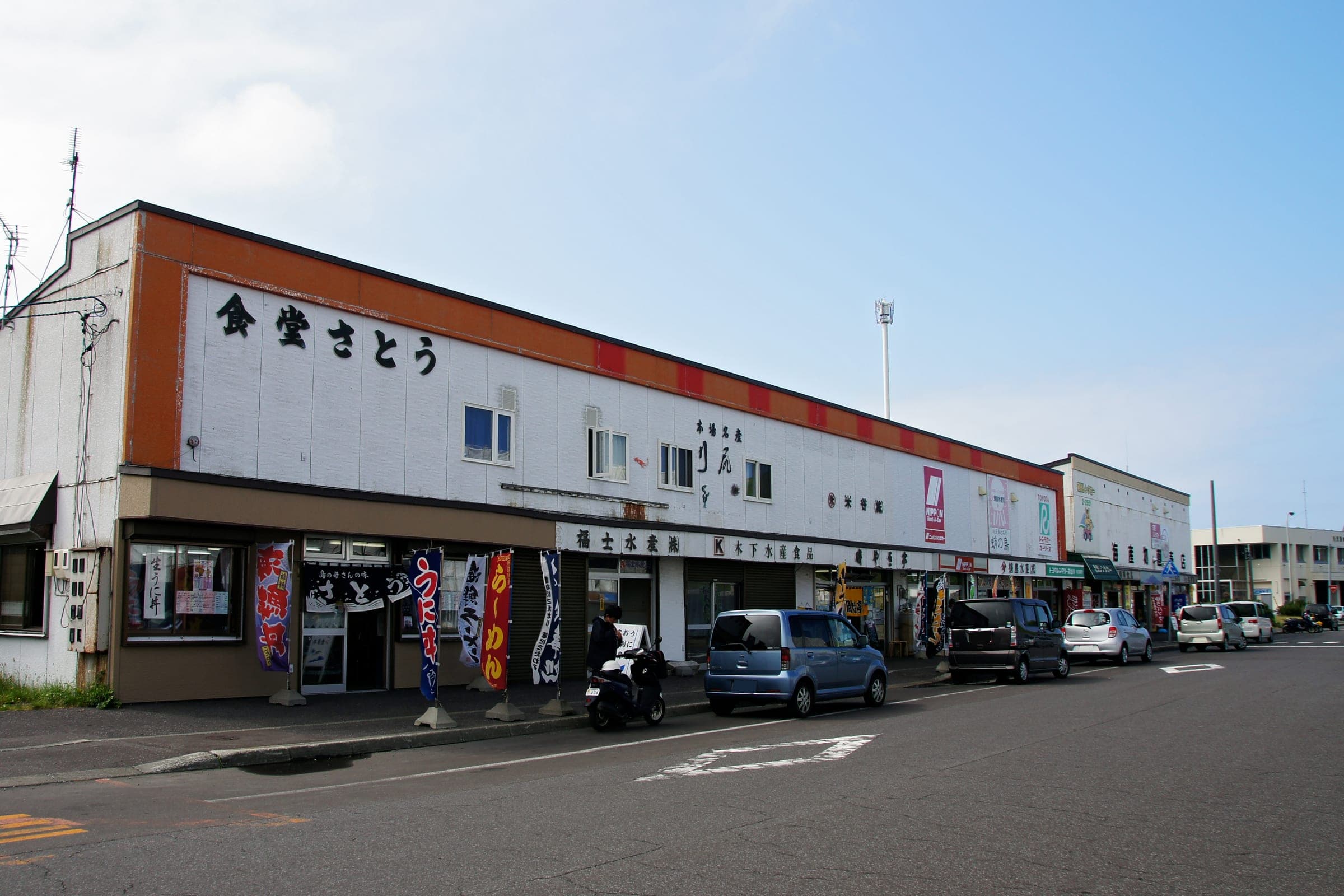 Shops and a restaurant line the main road near Oshidomari Port on Rishiri