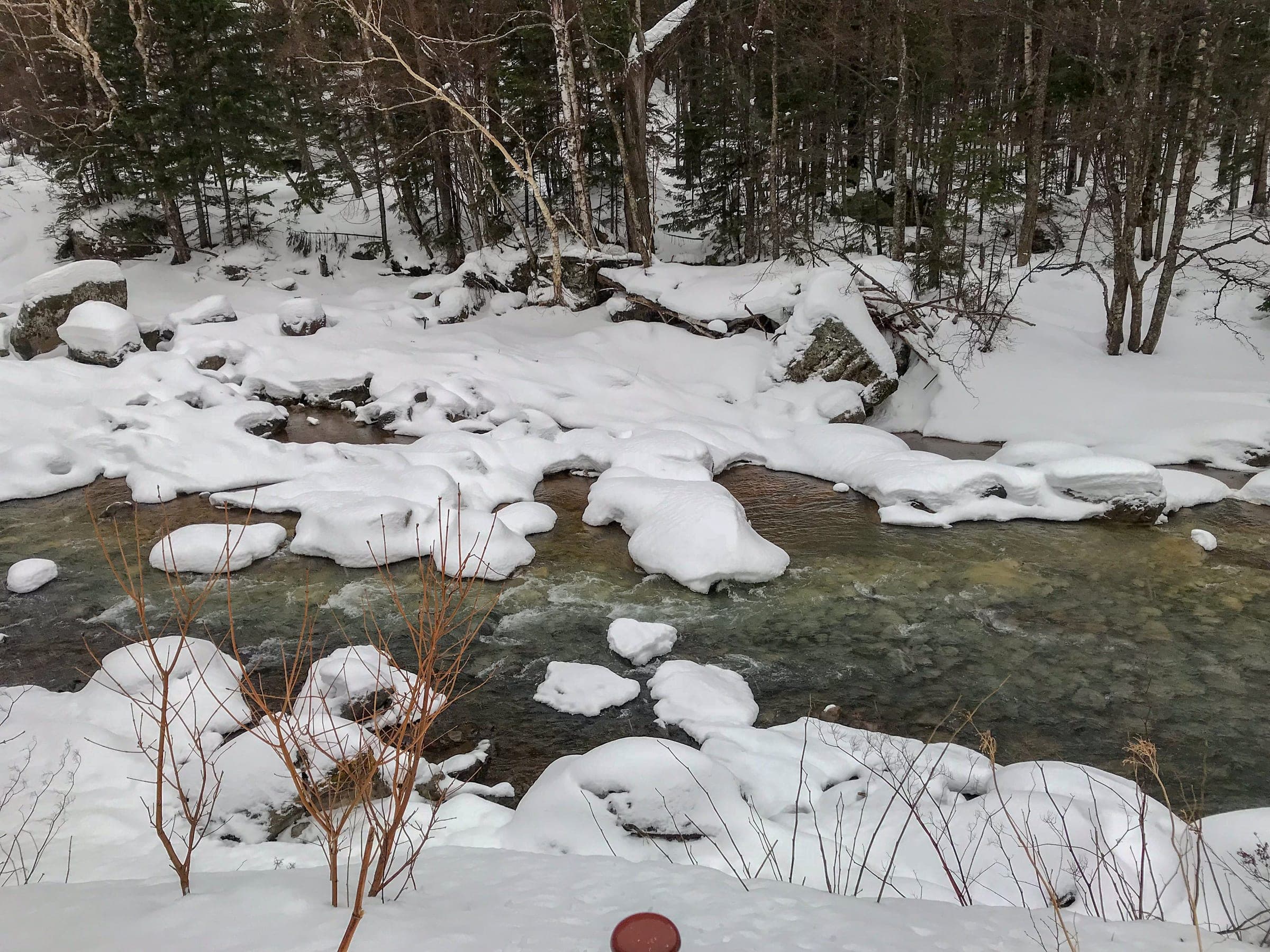 Snow piles up on the boulders of the river near Ryusei Falls in the Sounkyo gorge