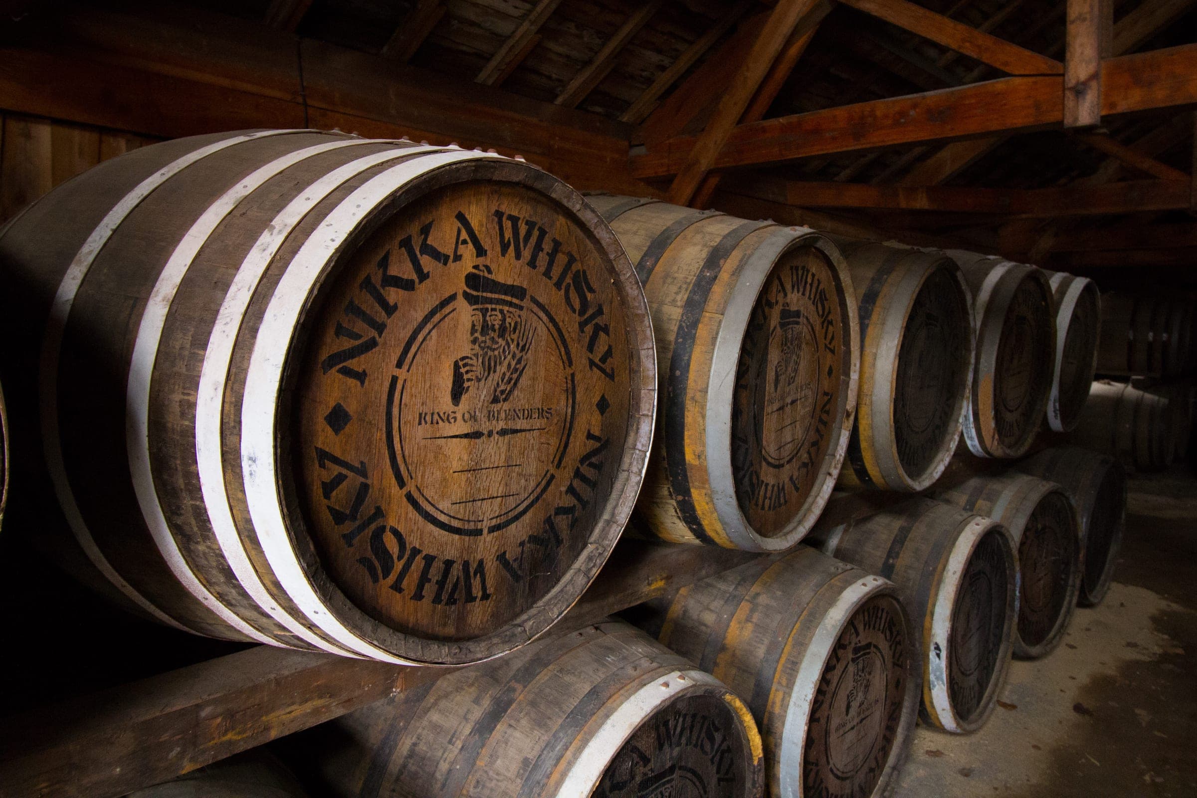 Rows of Nikka whisky casks rest in a dim warehouse at the Yoichi distillery