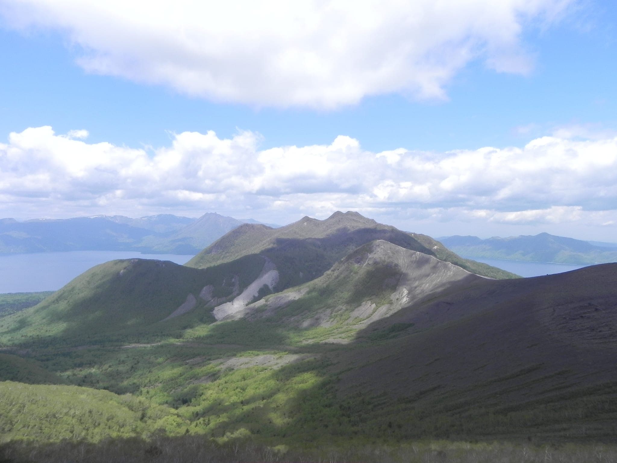 The green ridges of Fuppushi-dake fall toward Lake Shikotsu in early summer