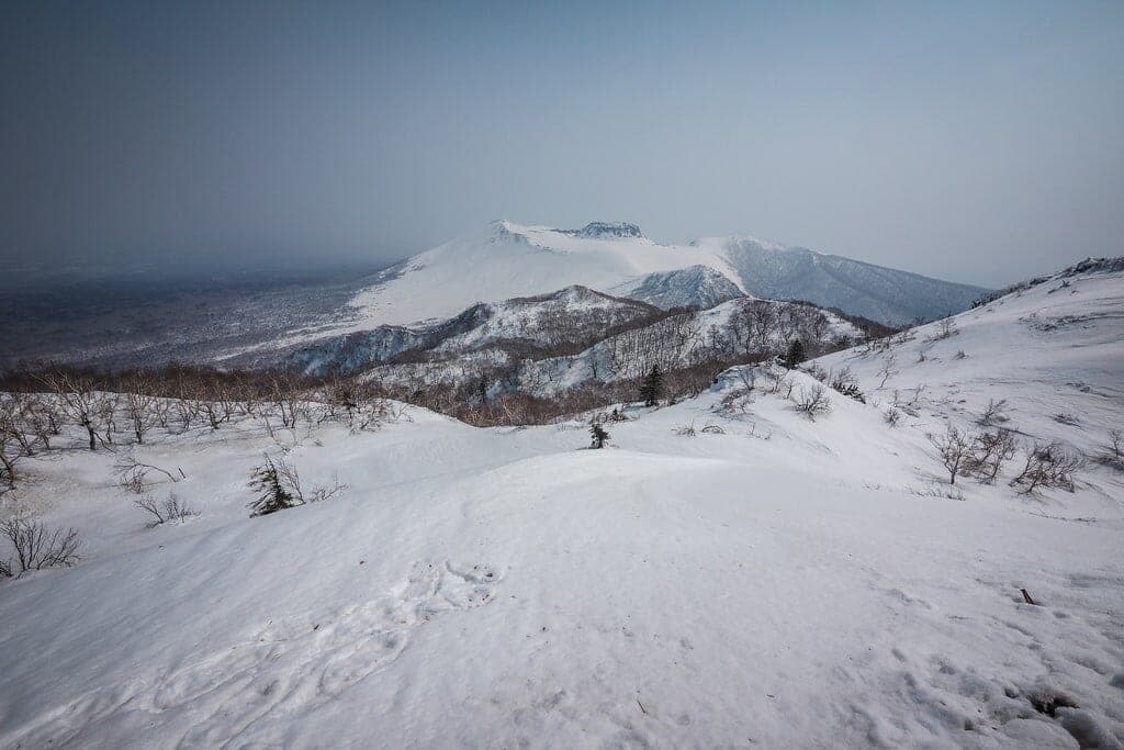 A skier looks out from the north ridge of Fuppushi-dake near Lake Shikotsu