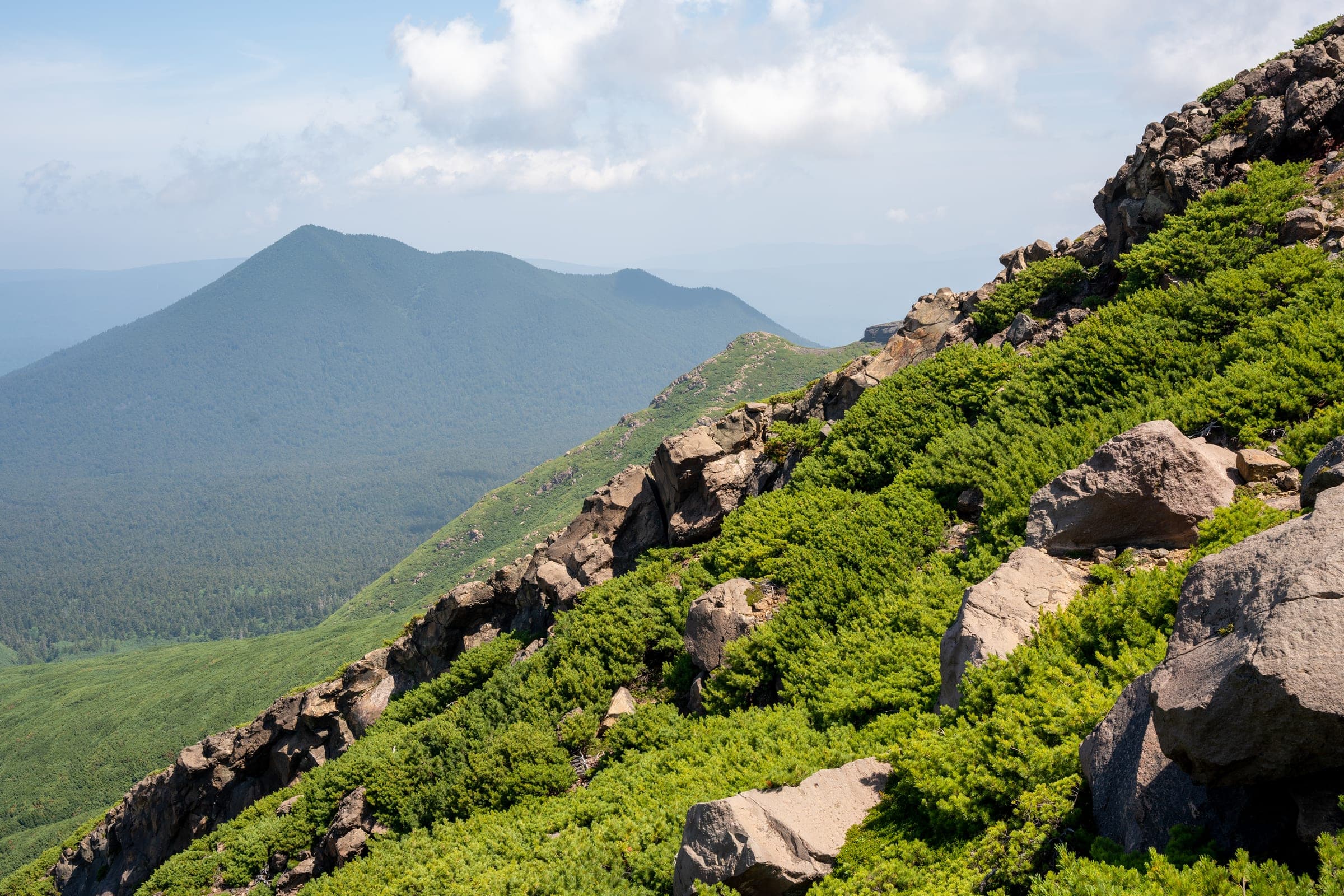 Fuppushi-dake seen from the south-southwest in summer, with rocky slopes in the foreground