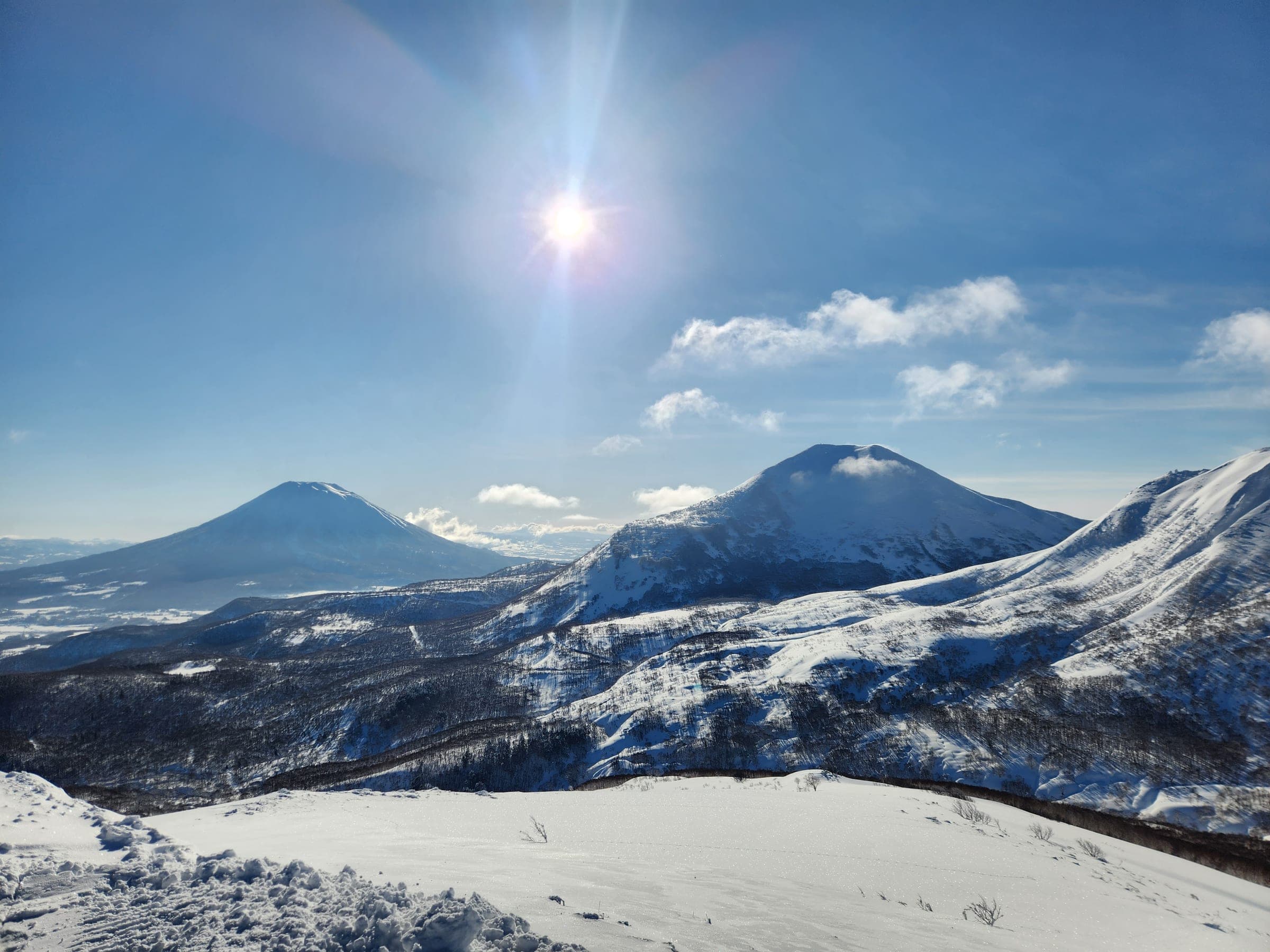 Mt. Yotei and Niseko Annupuri seen from a snowy ridge in the Niseko range
