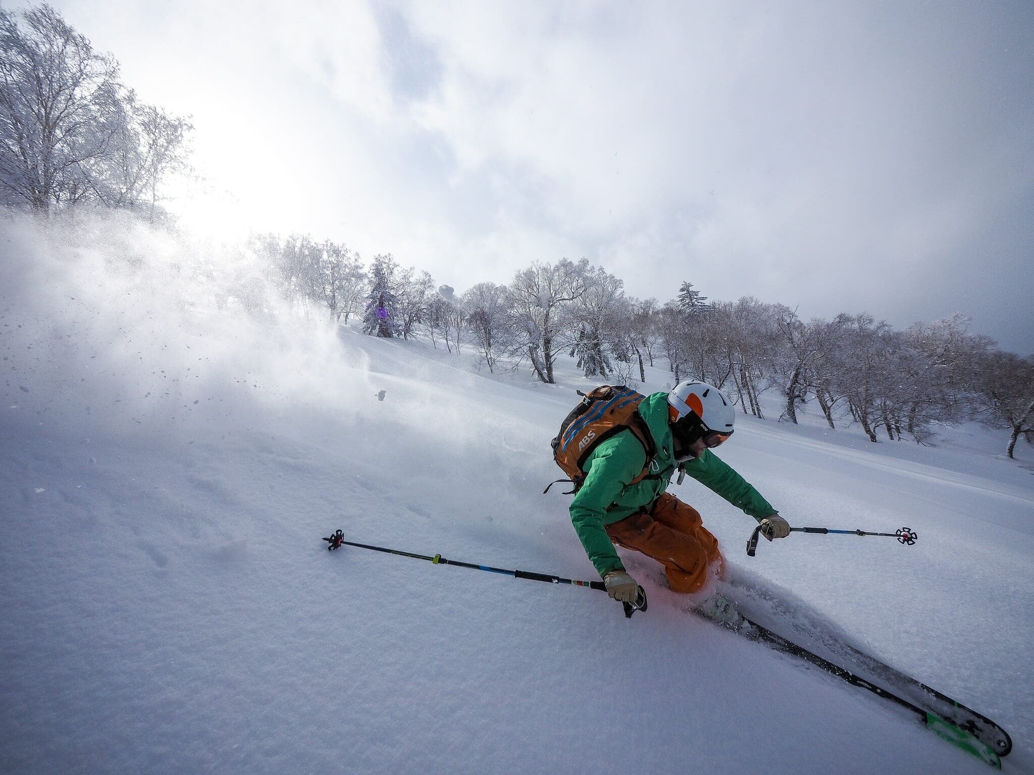 A skier sprays powder down an open glade on the Hiyamizu-sawa route of Sapporo-dake